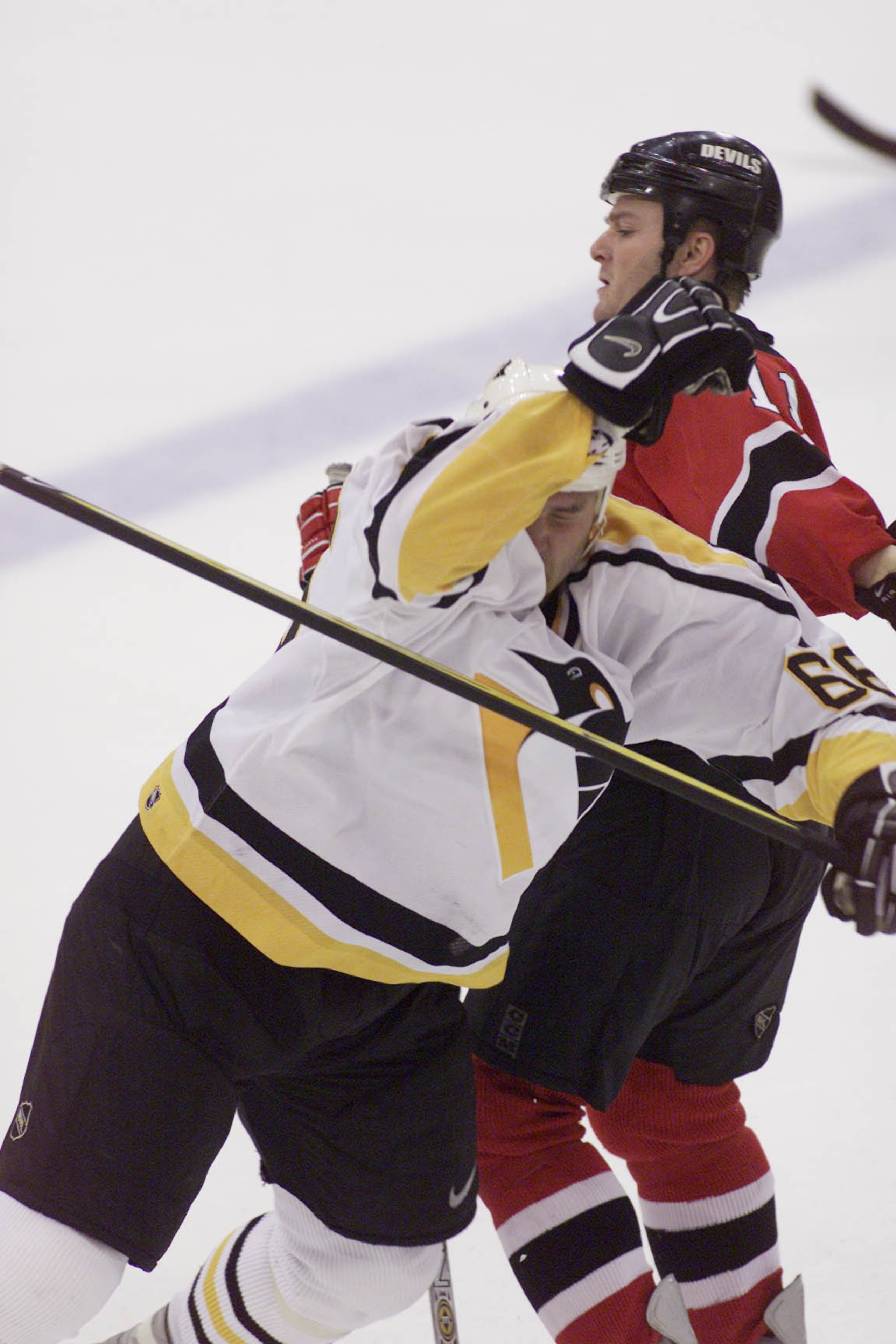 17 May 2001:  Mario Lemieux #66 of the Pittsburgh Penguins struggles against John Madden #11 of the New Jersey Devils during Game 3 of the Eastern Conference Finals at Mellon Arena in Pittsburgh, Pennsylvania.The Devils win the game 3-0, putting them in a
