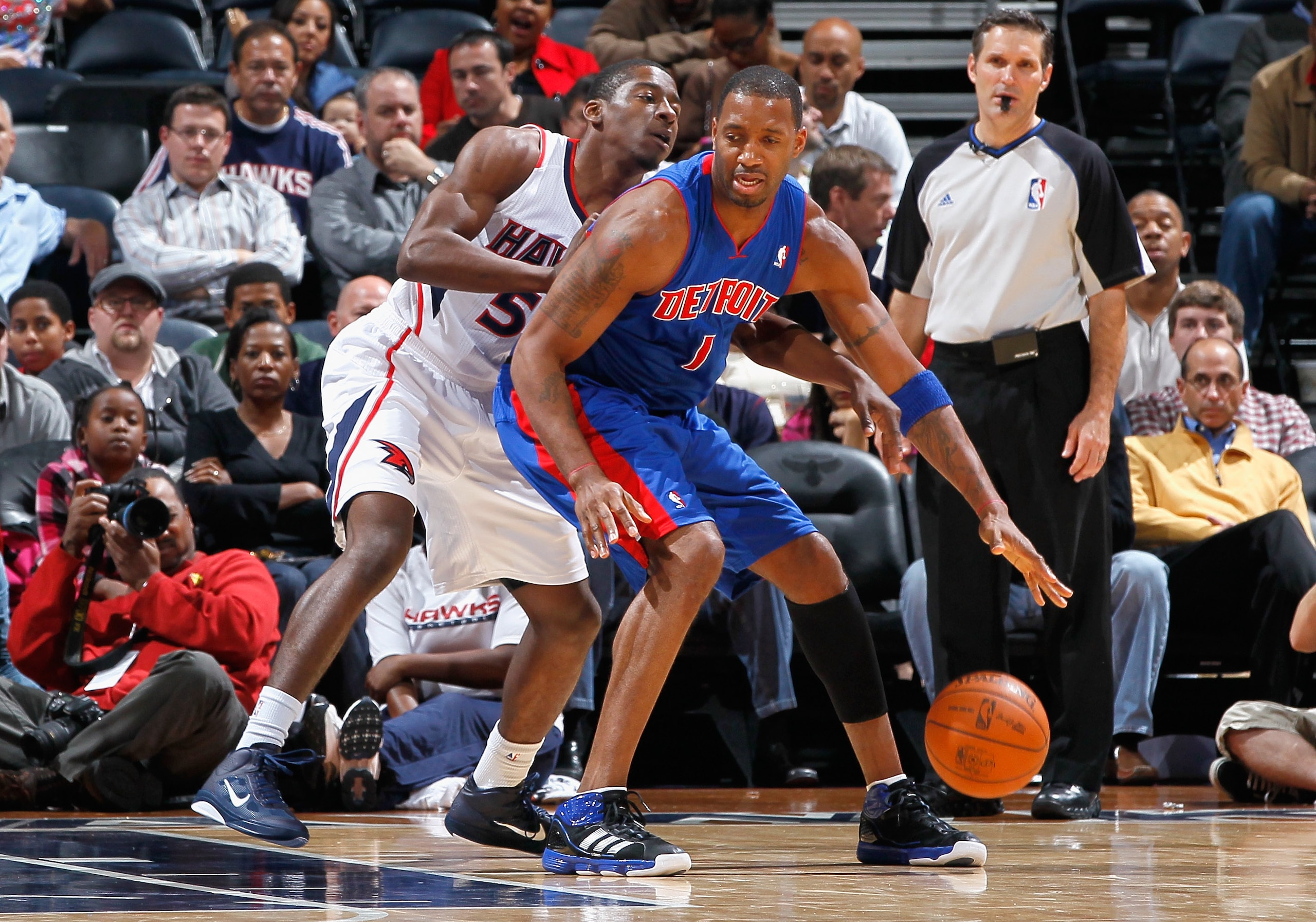ATLANTA - NOVEMBER 03: Tracy McGrady #1 of the Detroit Pistons against Jordan Crawford #55 of the Atlanta Hawks at Philips Arena on November 3, 2010 in Atlanta, Georgia. NOTE TO USER: User expressly acknowledges and agrees that, by downloading and/or us ATLANTA - NOVEMBER 03: Tracy McGrady #1 of the Detroit Pistons against Jordan Crawford #55 of the Atlanta Hawks at Philips Arena on November 3, 2010 in Atlanta, Georgia. NOTE TO USER: User expressly acknowledges and agrees that, by downloading and/or us