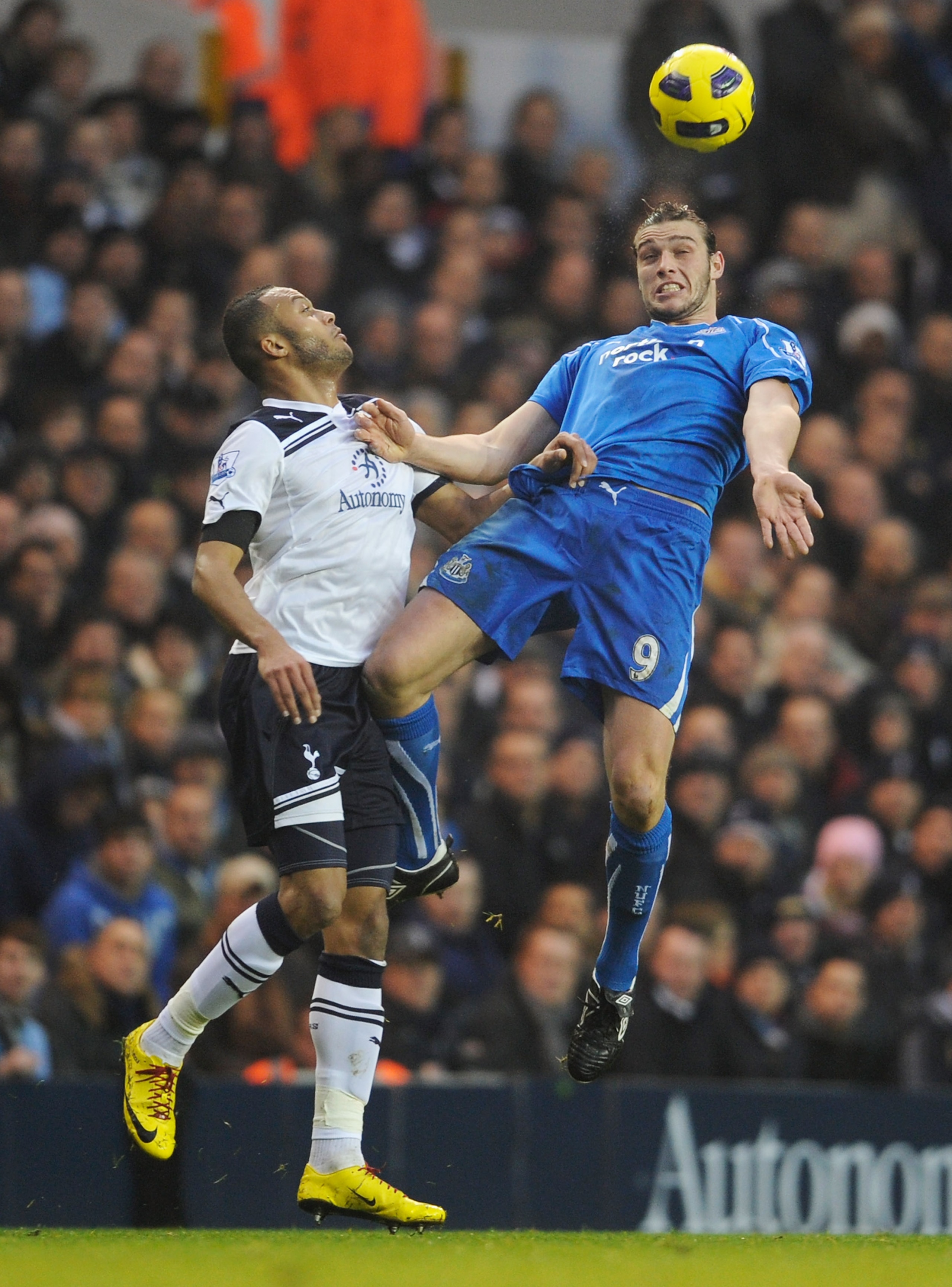 LONDON, ENGLAND - DECEMBER 28: Andy Carroll of Newcastle United wins a header against Younes Kaboul of Tottenham Hotspur during the Barclays Premier League match between Tottenham Hotspur and Newcastle United at White Hart Lane on December 28, 2010 in Lon