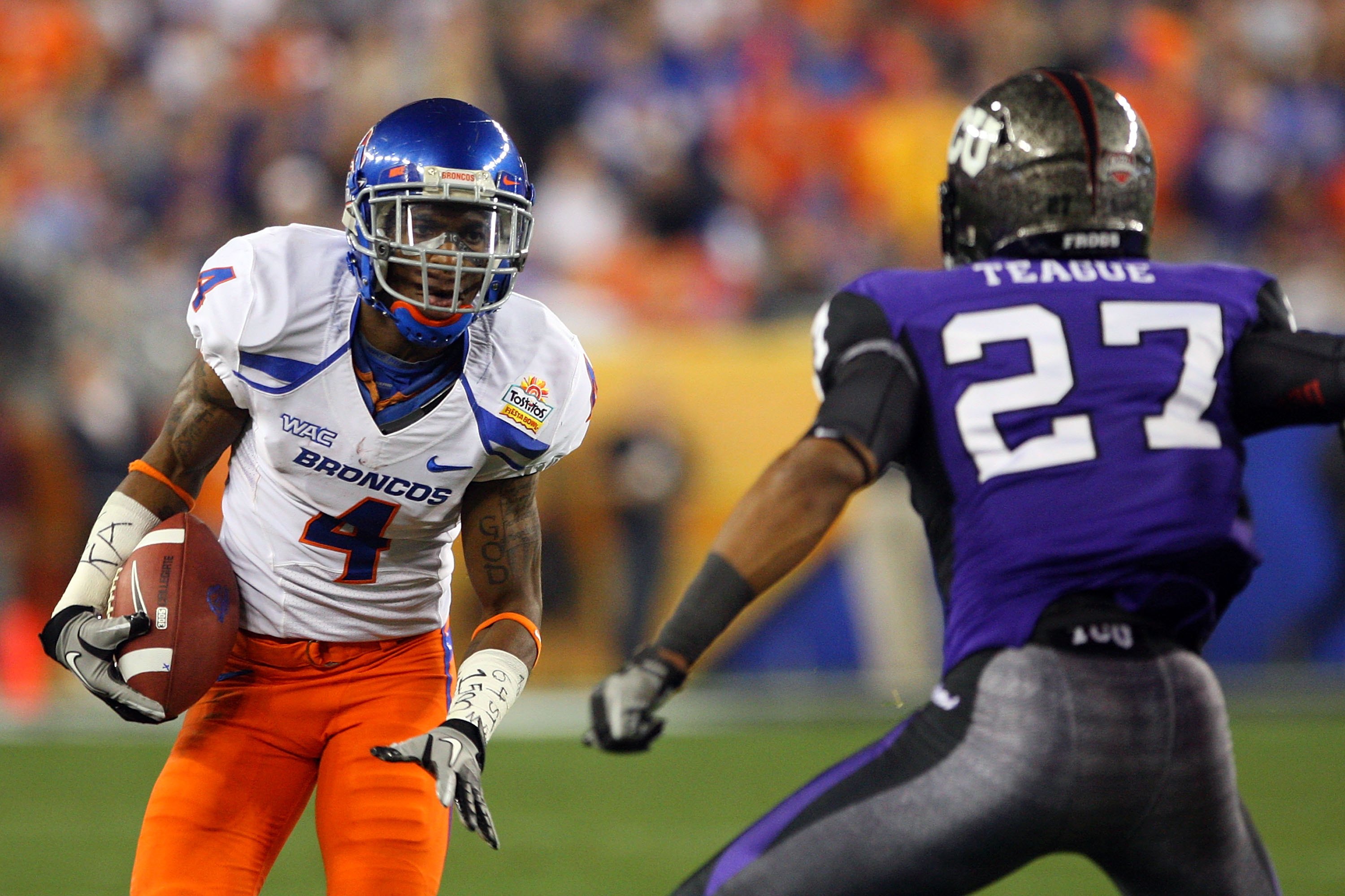 GLENDALE, AZ - JANUARY 04: Titus Young #4 of the Boise State Broncos runs after a catch against Jason Teague #27 of the TCU Horned Frogs during the Tostitos Fiesta Bowl at the Universtity of Phoenix Stadium on January 4, 2010 in Glendale, Arizona. (Phot