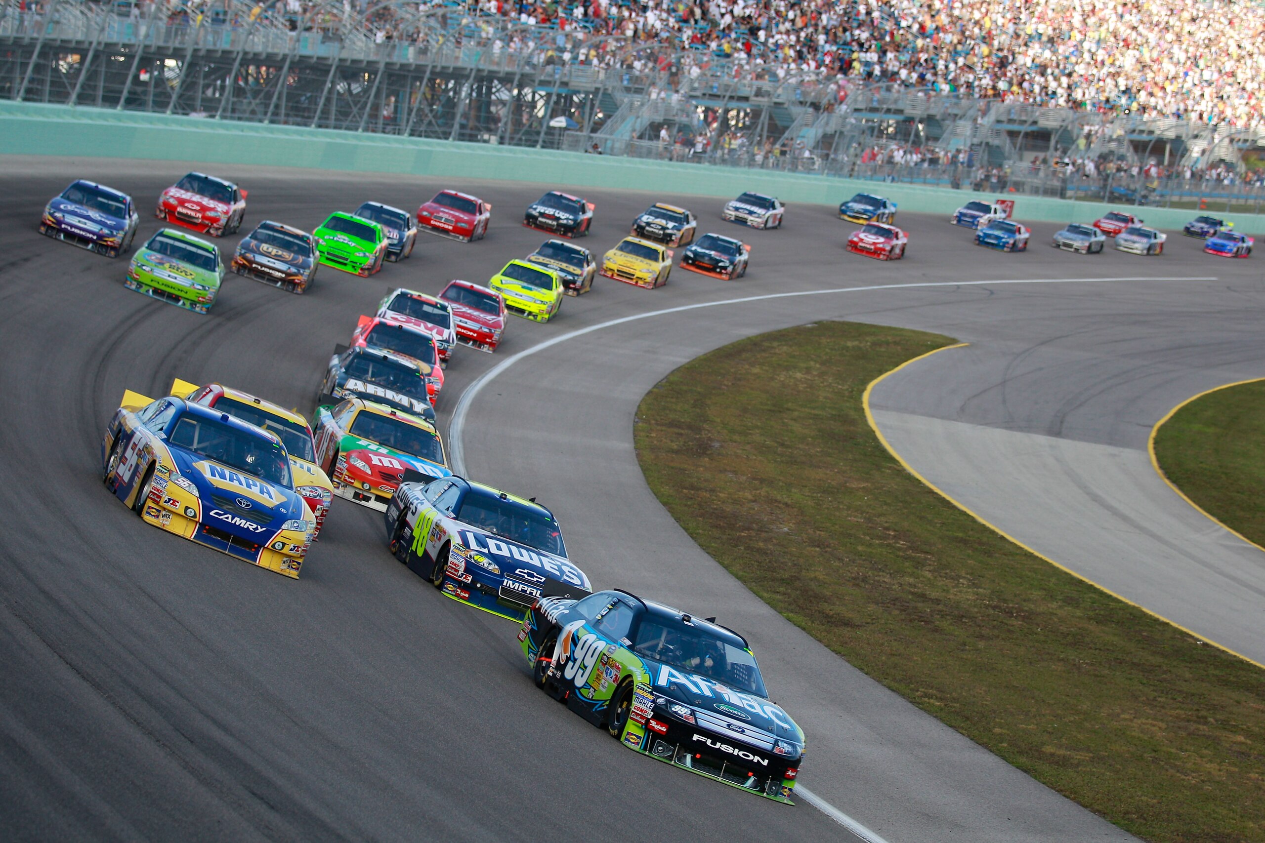 HOMESTEAD, FL - NOVEMBER 21:  Carl Edwards, driver of the #99 Aflac Ford, leads the field during the NASCAR Sprint Cup Series Ford 400 at Homestead-Miami Speedway on November 21, 2010 in Homestead, Florida.  (Photo by Chris Graythen/Getty Images)