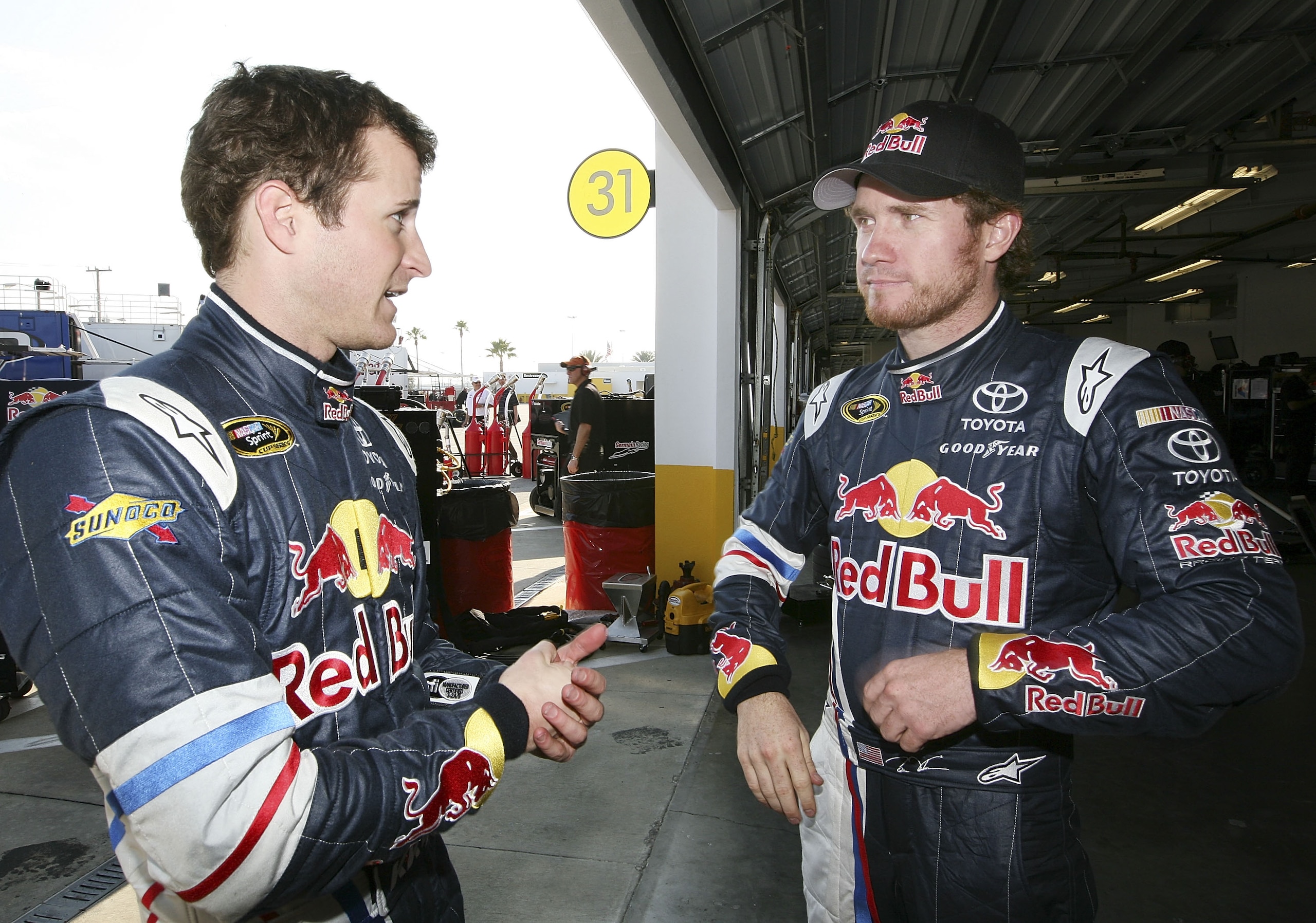 DAYTONA BEACH, FL - JANUARY 20:  Kasey Kahne, driver of the #4 Red Bull Toyota talks with Brain Vickers, driver of the #83 Red Bull Toyota during testing at Daytona International Speedway on January 20, 2011 in Daytona Beach, Florida.  (Photo by Jerry Mar