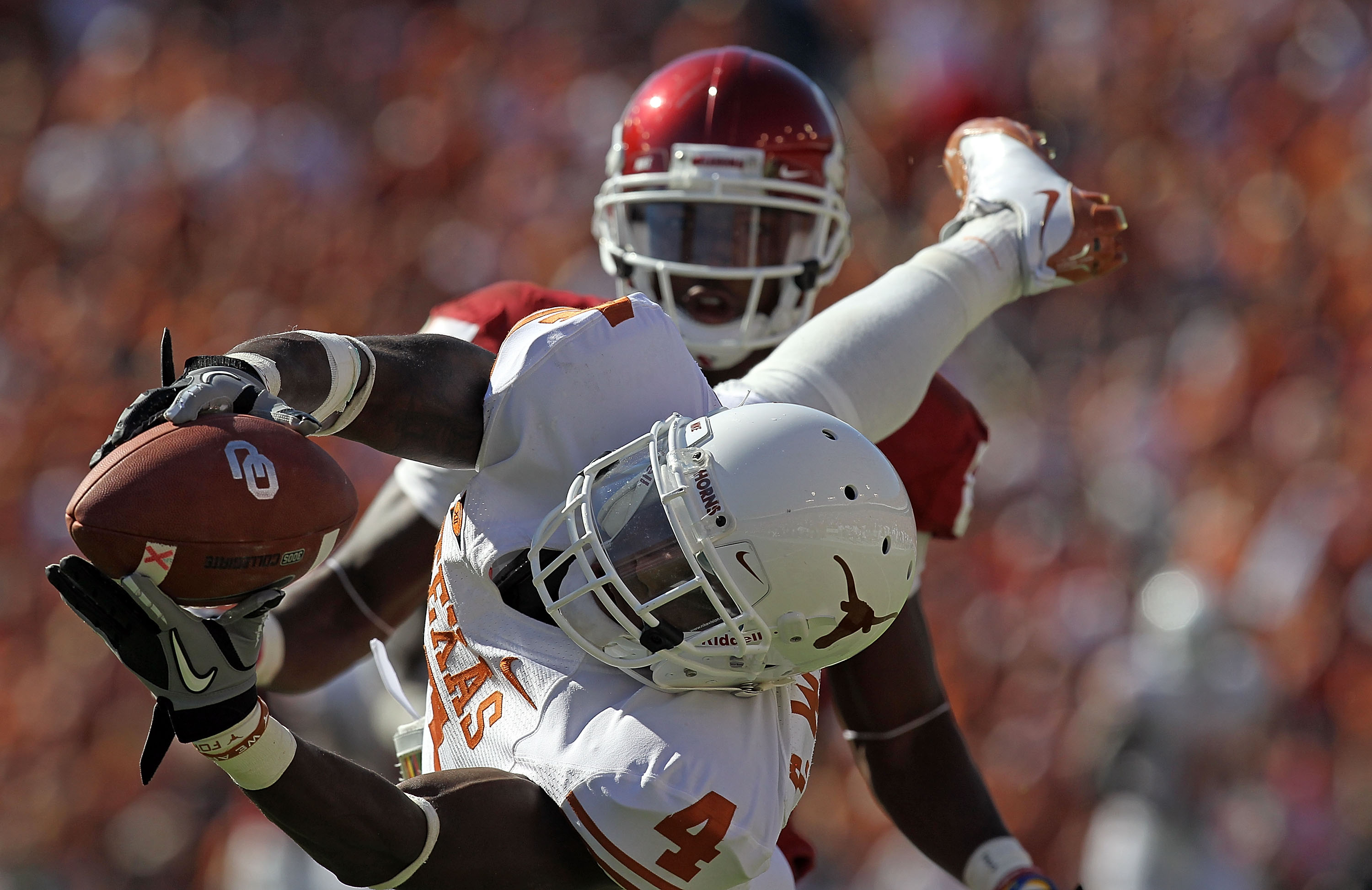 DALLAS - OCTOBER 02: Cornerback Aaron Williams #4 of the Texas Longhorns drops a pass intended for Ryan Broyles #85 of the Oklahoma Sooners in the second quarter at the Cotton Bowl on October 2, 2010 in Dallas, Texas. (Photo by Ronald Martinez/Getty Ima