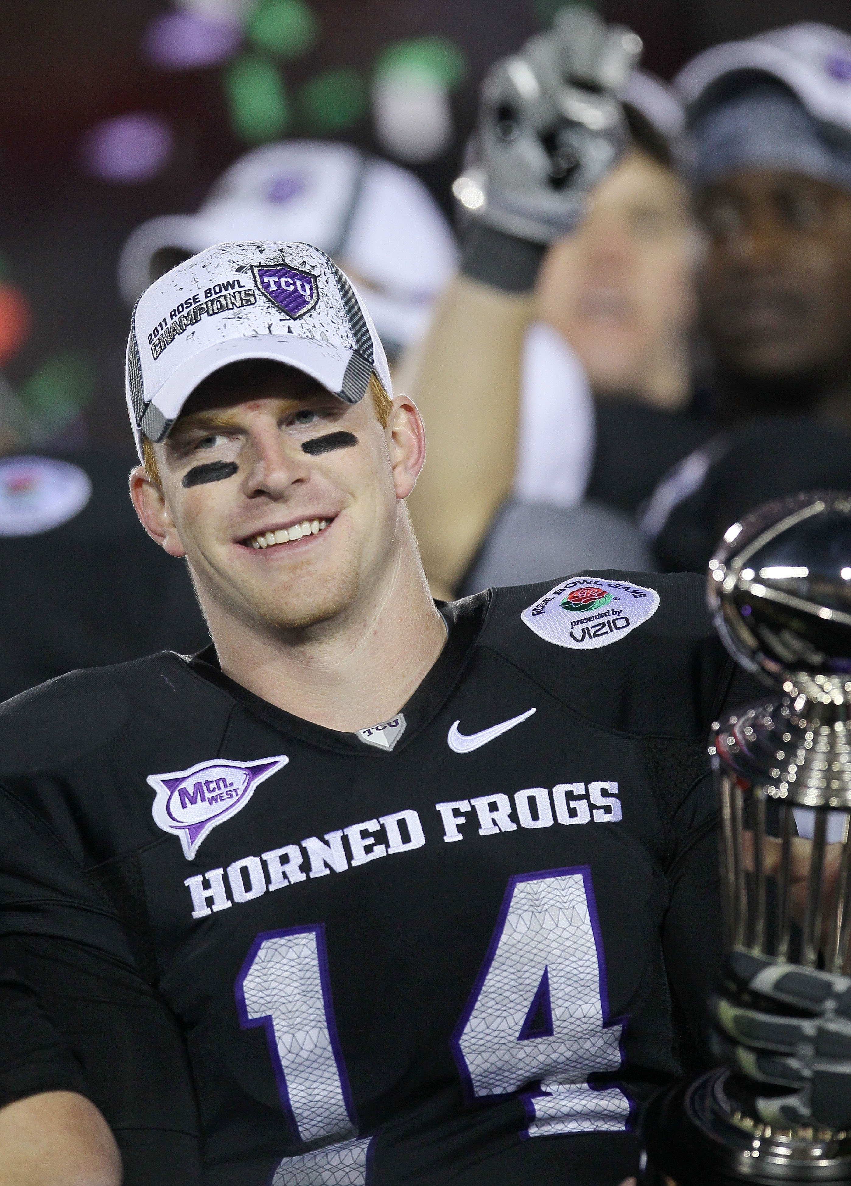 PASADENA, CA - JANUARY 01: Quarterback Andy Dalton #14 of the TCU Horned Frogs celebrates with the Rose Bowl Championship Trophy after defeating the Wisconsin Badgers 21-19 in the 97th Rose Bowl game on January 1, 2011 in Pasadena, California. (Photo by
