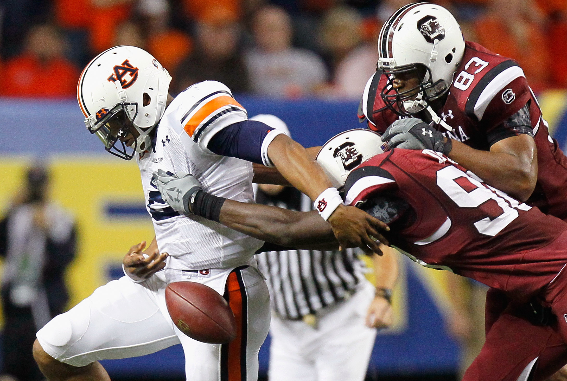 ATLANTA, GA - DECEMBER 04: Devin Taylor #98 and Cliff Matthews #83 of the South Carolina Gamecocks force a fumble by quarterback Cam Newton #2 of the Auburn Tigers during the 2010 SEC Championship at Georgia Dome on December 4, 2010 in Atlanta, Georgia.