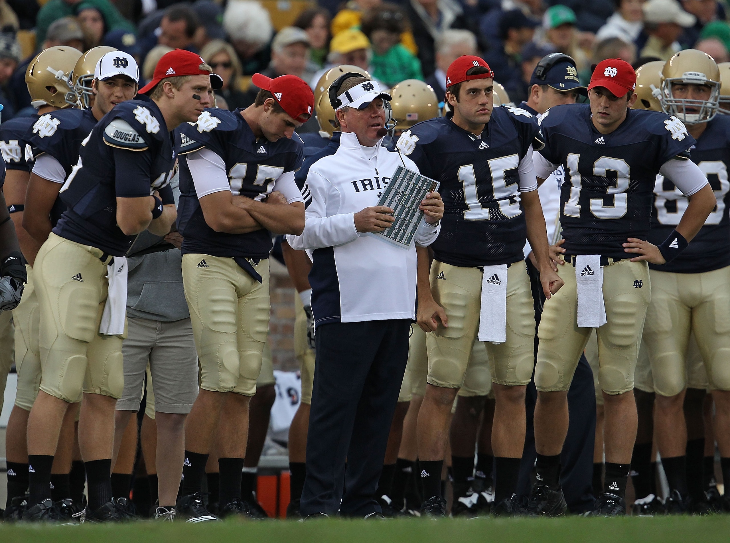 SOUTH BEND, IN - SEPTEMBER 25: Head coach Brian Kelly of the Notre Dame Fighting Irish along with quarterbacks (L-R) Nate Montana #16, Matthew Mulvey #17, Brian Castello and Tommy Rees #13 watch as their team takes on the Stanford Cardinal at Notre Dame S