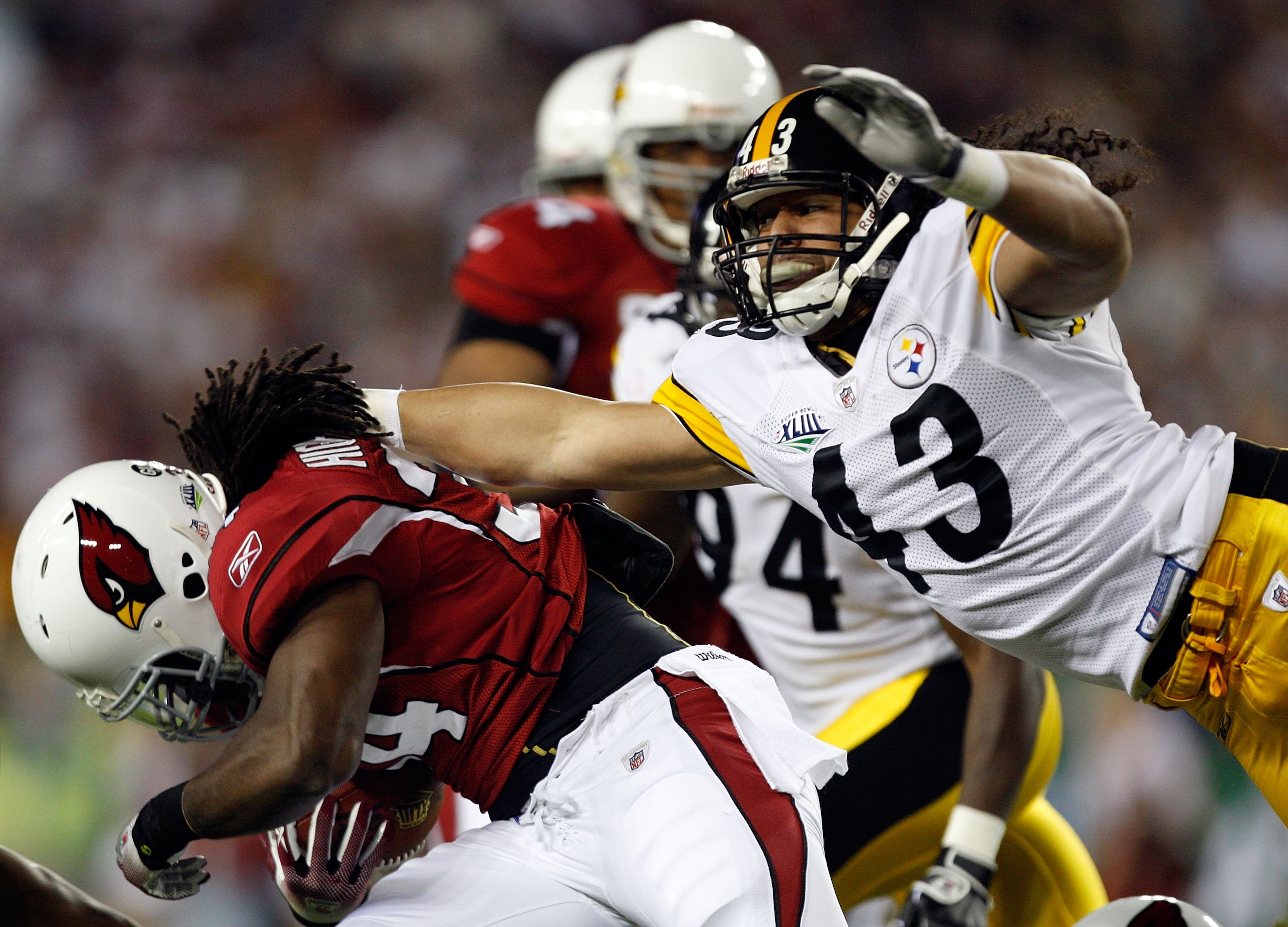 TAMPA, FL - FEBRUARY 01:  Troy Polamalu #43 of the Pittsburgh Steelers attempts to tackle Tim Hightower #34 of the Arizona Cardinals during the first quarter of Super Bowl XLIII on February 1, 2009 at Raymond James Stadium in Tampa, Florida.  (Photo by St