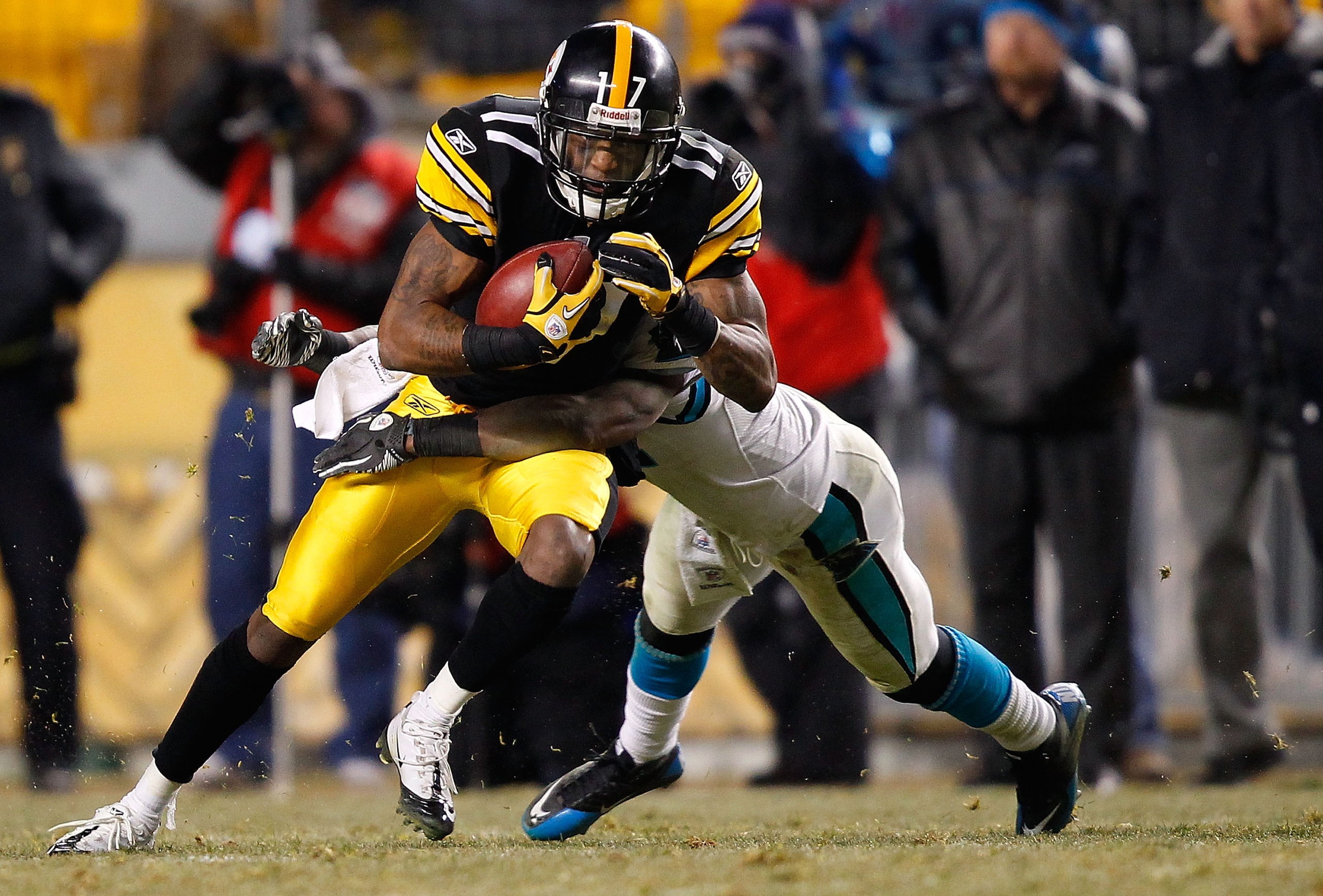 PITTSBURGH - DECEMBER 23: Mike Wallace #17 of the Pittsburgh Steelers attempts to break a tackle after catching a pass against the Carolina Panthers during the game on December 23, 2010 at Heinz Field in Pittsburgh, Pennsylvania. (Photo by Jared Wickerh PITTSBURGH - DECEMBER 23: Mike Wallace #17 of the Pittsburgh Steelers attempts to break a tackle after catching a pass against the Carolina Panthers during the game on December 23, 2010 at Heinz Field in Pittsburgh, Pennsylvania. (Photo by Jared Wickerh
