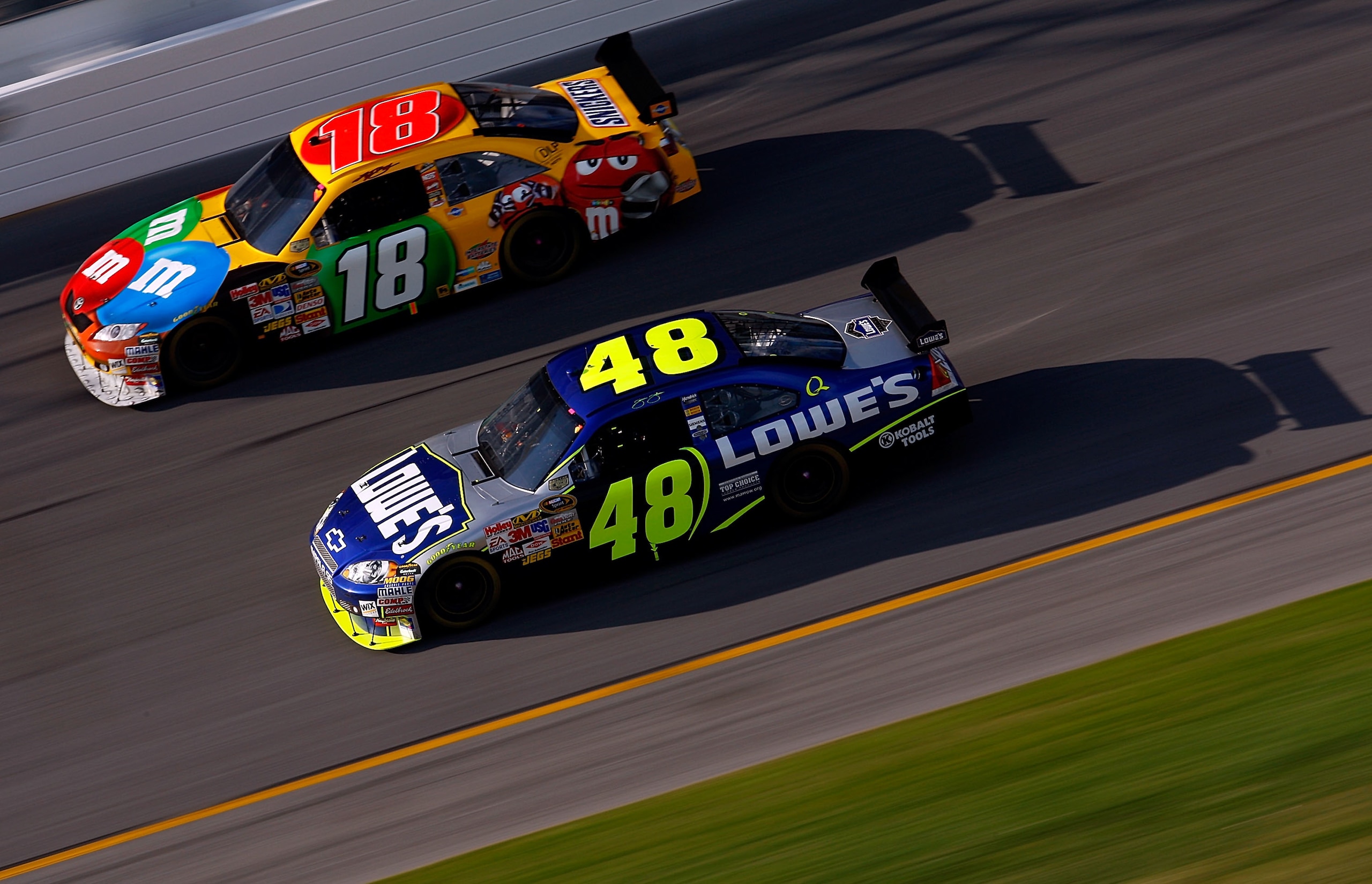 DAYTONA BEACH, FL - FEBRUARY 17:  Kyle Busch, driver of the #18 M&M's Toyota, races Jimmie Johnson, driver of the #48 Lowe's Chevrolet, during the NASCAR Sprint Cup Series Daytona 500 at Daytona International Speedway on February 17, 2008 in Daytona Beach