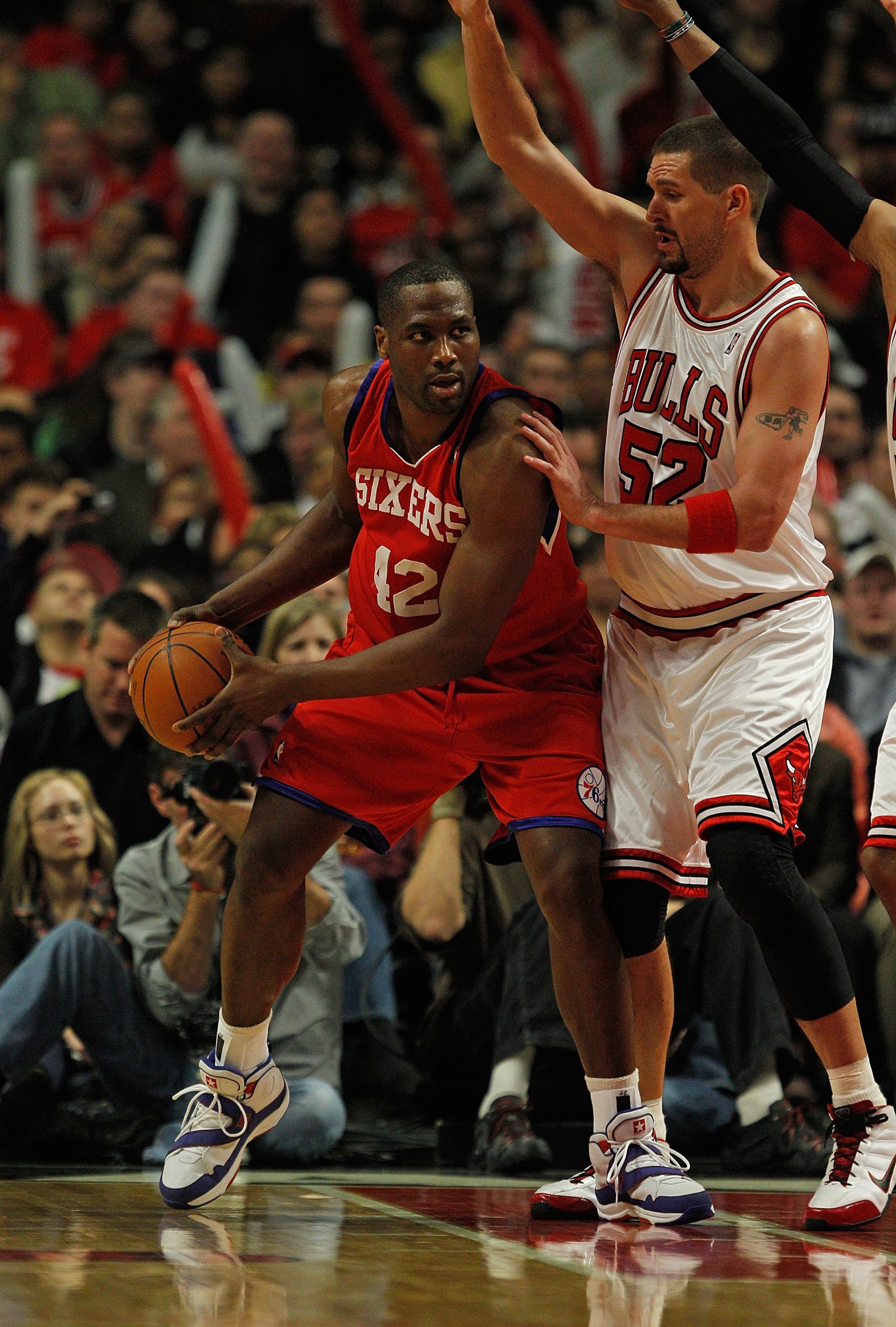CHICAGO - FEBRUARY 20: Elton Brand #42 of the Philadelphia 76ers looks to pass under pressure from Brad Miller #52 of the Chicago Bulls at the United Center on February 20, 2010 in Chicago, Illinois. The Bulls defeated the 76ers 122-90. NOTE TO USER: User
