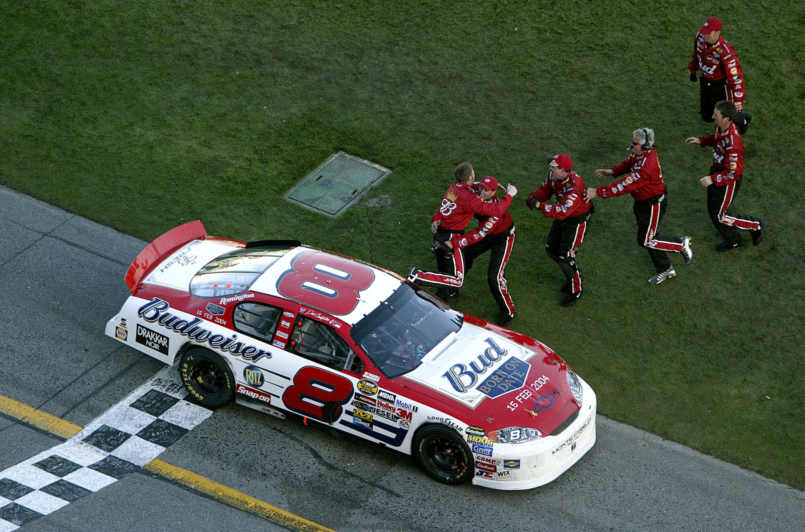 DAYTONA BEACH, FL - FEBRUARY 15:  Dale Earnhardt Jr. driver of the #8 Budweiser Chevrolet is congratuated by his crew members as they celebrate following his win in the NASCAR Nextel Cup Daytona 500 on February 15, 2004 at Daytona International Speedway i