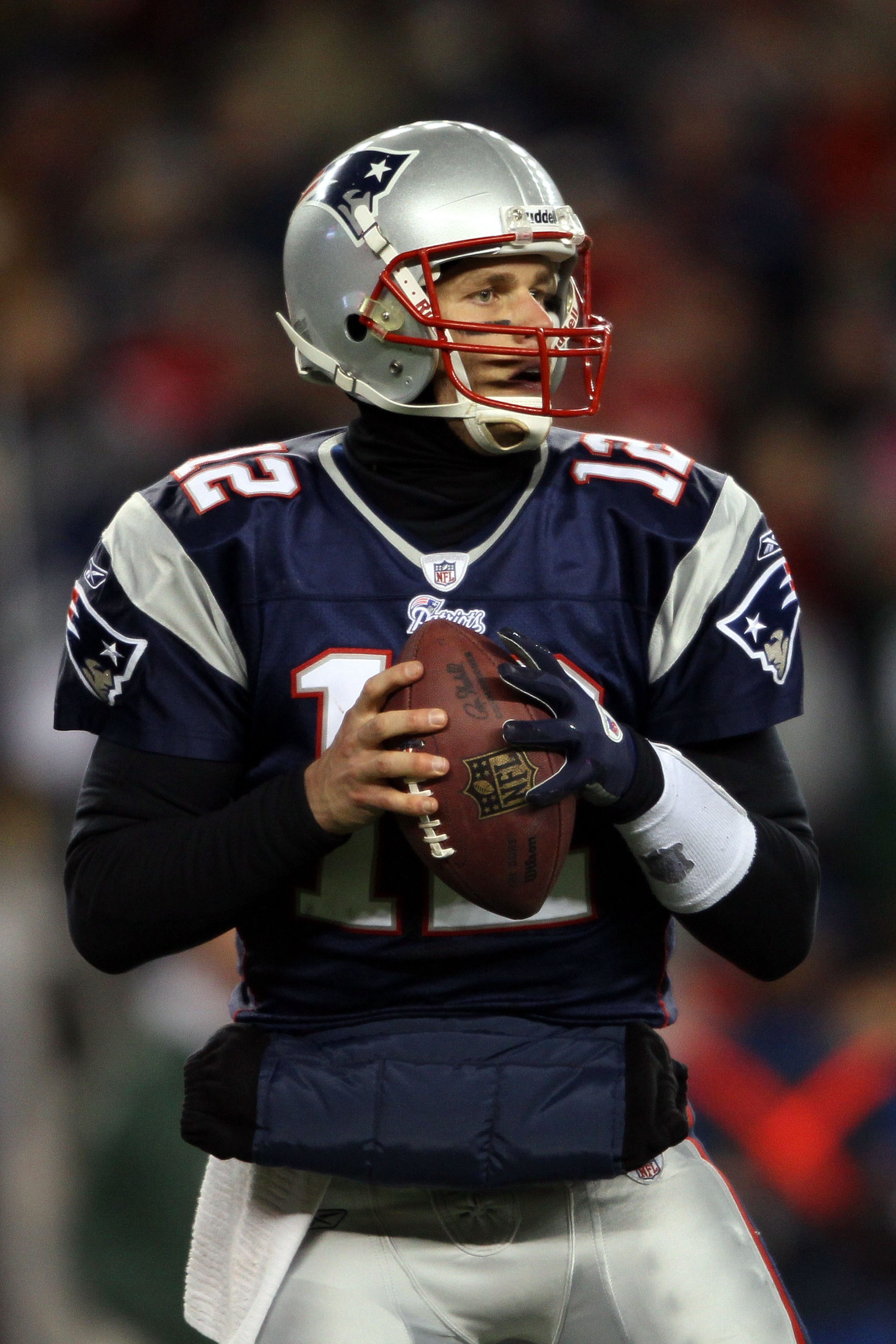 FOXBORO, MA - JANUARY 16:  Tom Brady #12 of the New England Patriots drops back during their 2011 AFC divisional playoff game against the New York Jets at Gillette Stadium on January 16, 2011 in Foxboro, Massachusetts.  (Photo by Elsa/Getty Images)