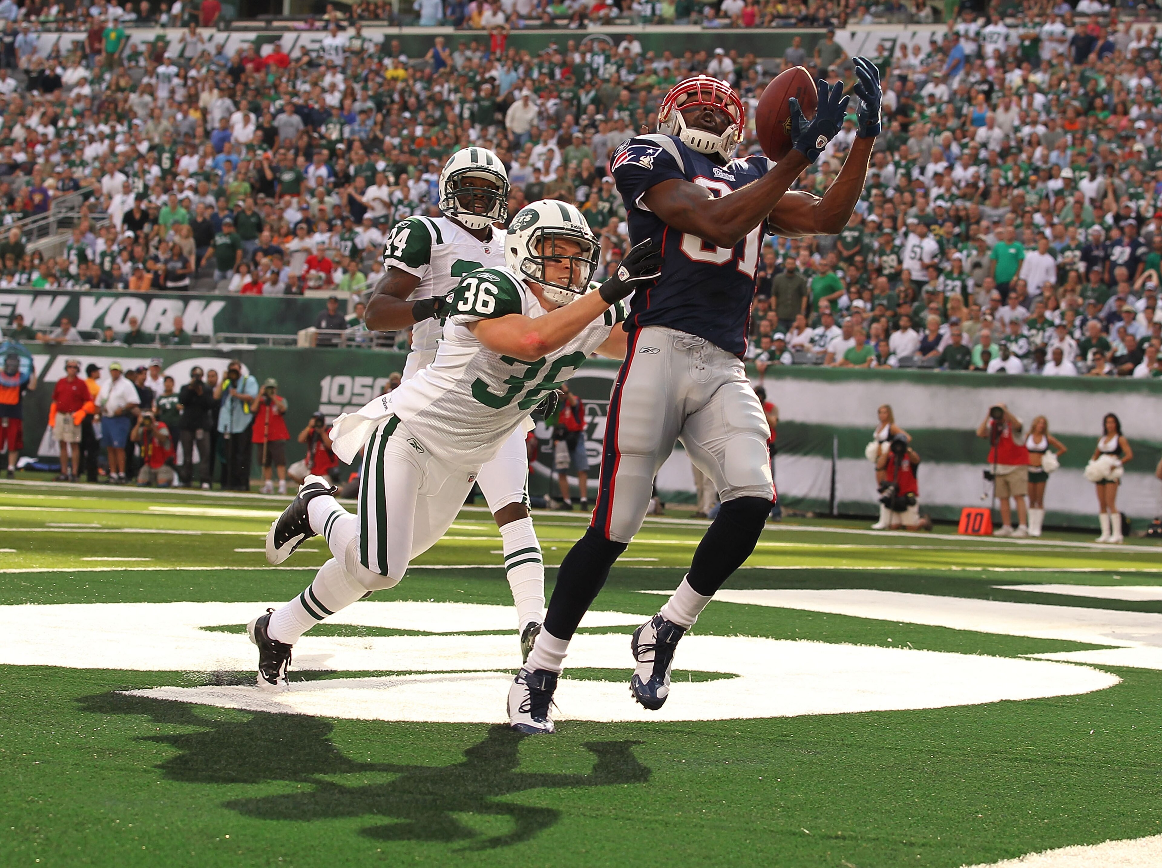 EAST RUTHERFORD, NJ - SEPTEMBER 19: Jim Leonhard #36 of the New York Jets defends against Randy Moss #81 of the New England Patriots on September 19, 2010 at the New Meadowlands Stadium in East Rutherford, New Jersey. There was no touchdown on the play. EAST RUTHERFORD, NJ - SEPTEMBER 19: Jim Leonhard #36 of the New York Jets defends against Randy Moss #81 of the New England Patriots on September 19, 2010 at the New Meadowlands Stadium in East Rutherford, New Jersey. There was no touchdown on the play.