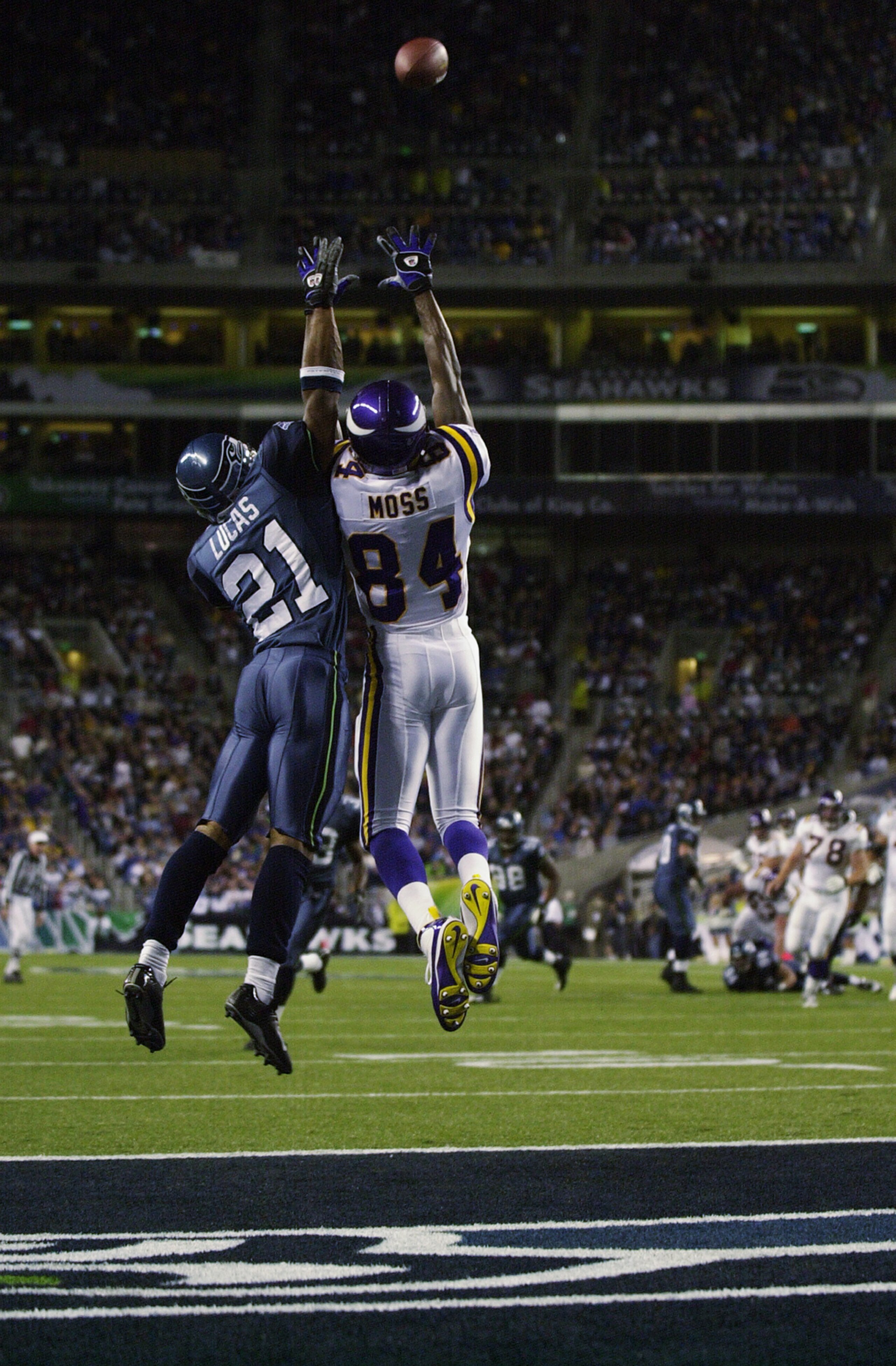 SEATTLE - SEPTEMBER 29:  Randy Moss #84 of the Minnesota Vikings leaps for the ball against Ken Lucas #21 of the Seattle Seahawks during the game on September 29, 2002 at Seahawks Stadium in Seattle, Washington.  The ball was batted away by Chavous.  The