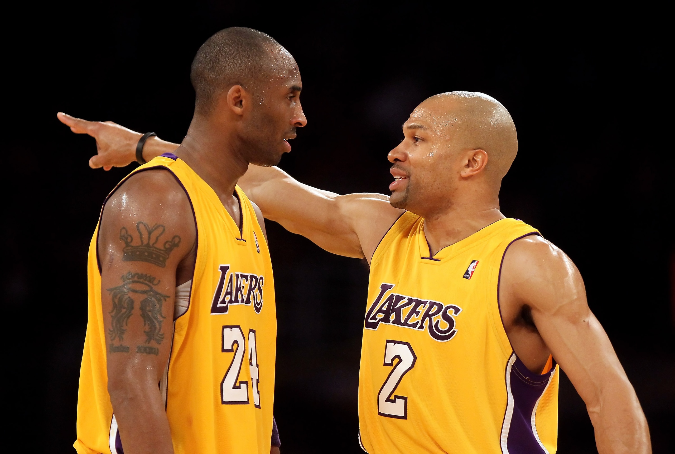 LOS ANGELES, CA - FEBRUARY 26:  Kobe Bryant #24 and Derek Fisher #2 of the Los Angeles Lakers talk in the second half against the Philadelphia 76ers at Staples Center on February 26, 2010 in Los Angeles, California. The Lakers defeated the 76ers 99-90. NO