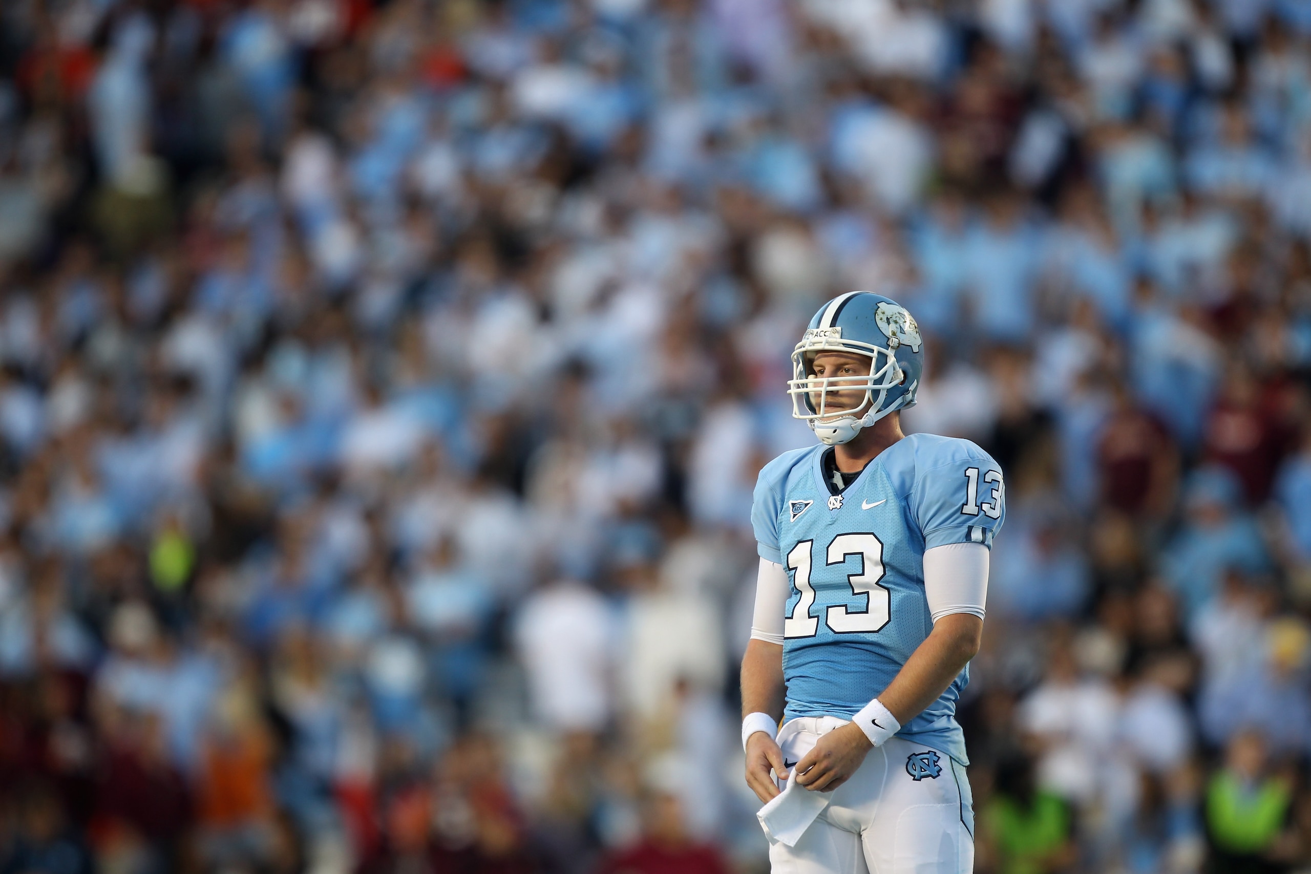 CHAPEL HILL, NC - NOVEMBER 13:  T.J. Yates #13 of the North Carolina Tar Heels waits for a play from the sidelines against the Virginia Tech Hokies during their game at Kenan Stadium on November 13, 2010 in Chapel Hill, North Carolina.  (Photo by Streeter
