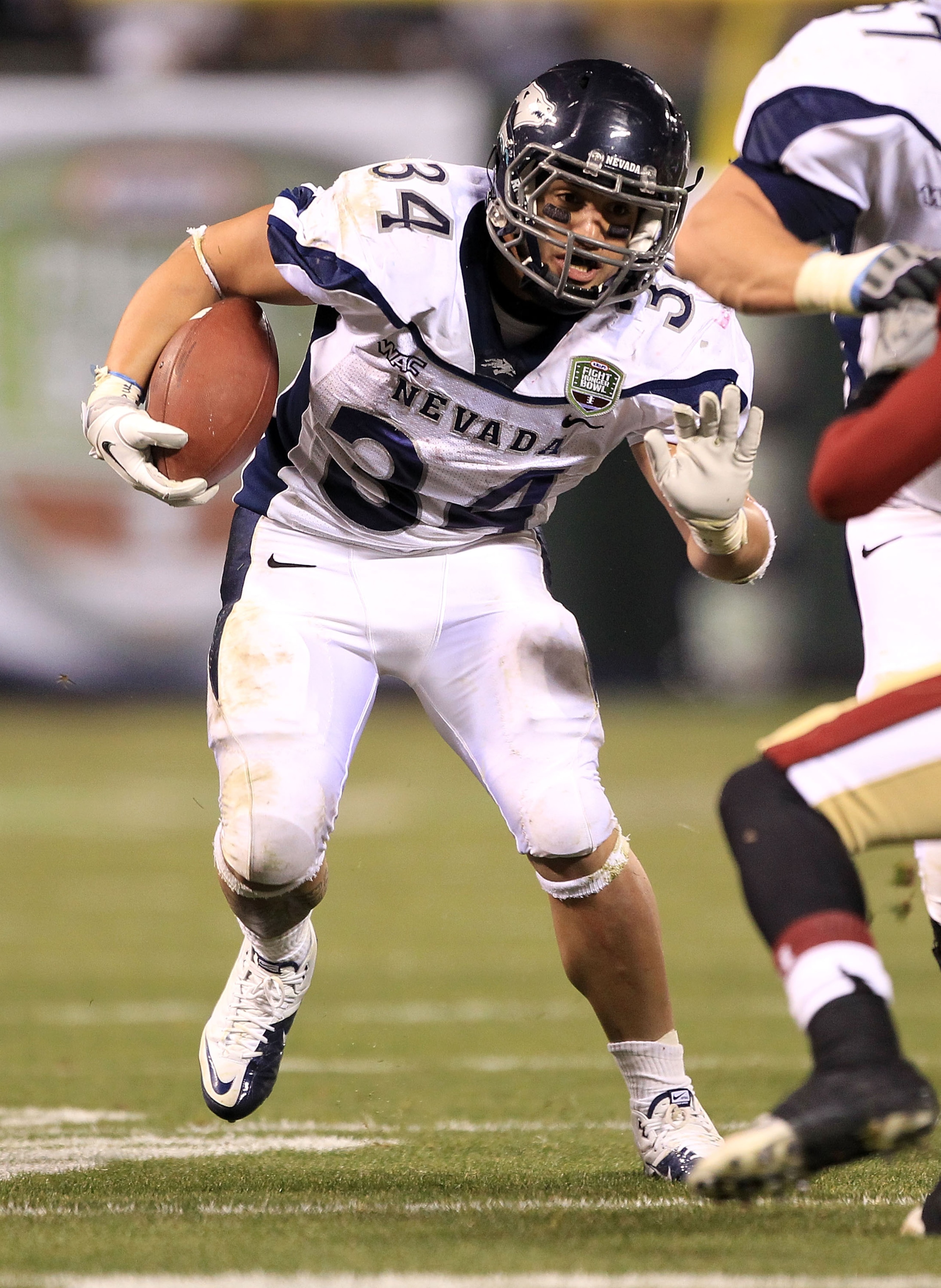 SAN FRANCISCO, CA - JANUARY 09:  Vai Taua #34 of the Nevada Wolf Pack runs with the ball against Boston College in the Kraft Fight Hunger Bowl at AT&T Park on January 9, 2011 in San Francisco, California.  (Photo by Ezra Shaw/Getty Images)