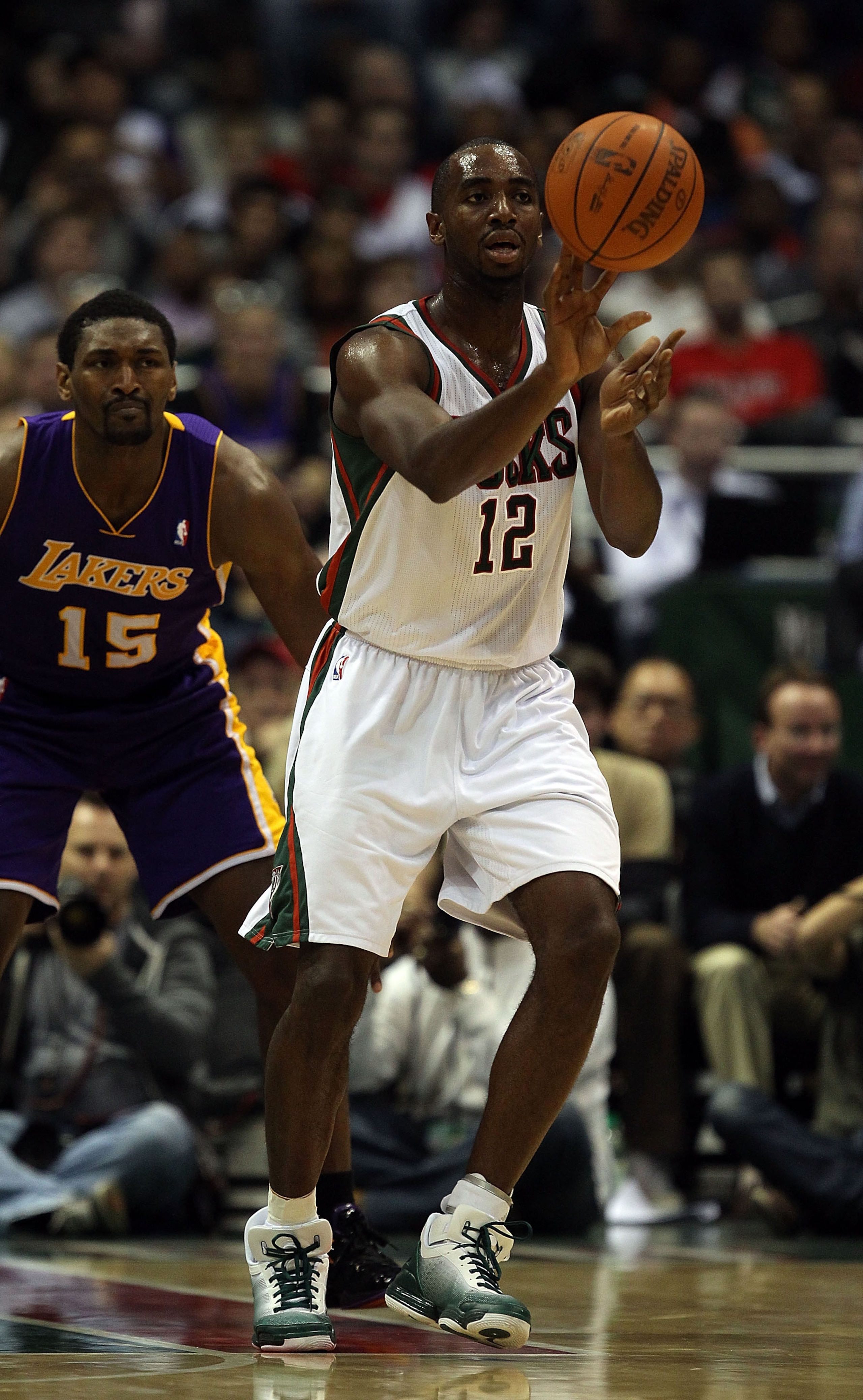 MILWAUKEE - NOVEMBER 16: Luc Richard Mbah a Moute #12 of the Milwaukee Bucks passes the ball in front of Ron Artest #15 of the Los Angeles Lakers at the Bradley Center on November 16, 2010 in Milwaukee, Wisconsin. The Lakers defeated the Bucks 118-107. NO