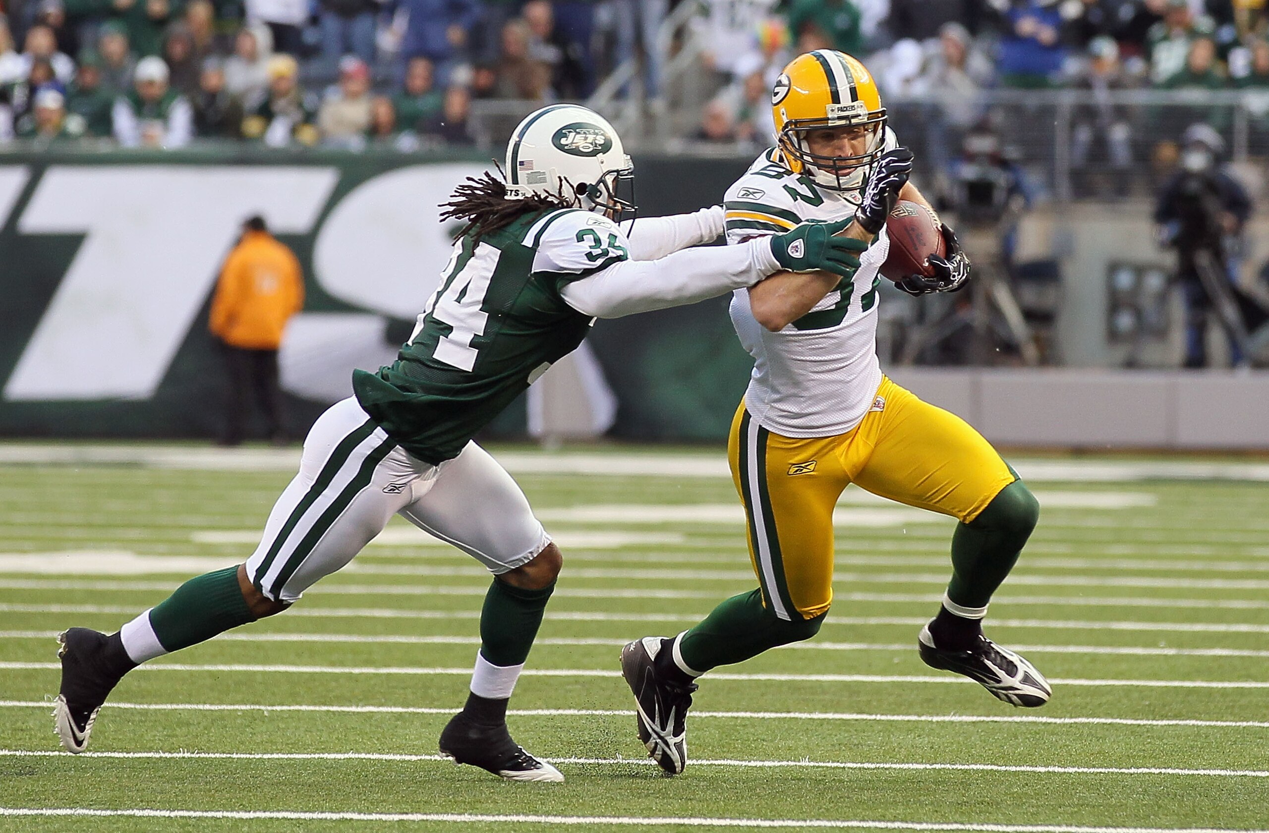EAST RUTHERFORD, NJ - OCTOBER 31:  Jordy Nelson #87 of the Green Bay Packers runs the ball against Marquice Cole #34 of the New York Jets on October 31, 2010 at the New Meadowlands Stadium in East Rutherford, New Jersey. The Packers defeated the Jets 9-0.