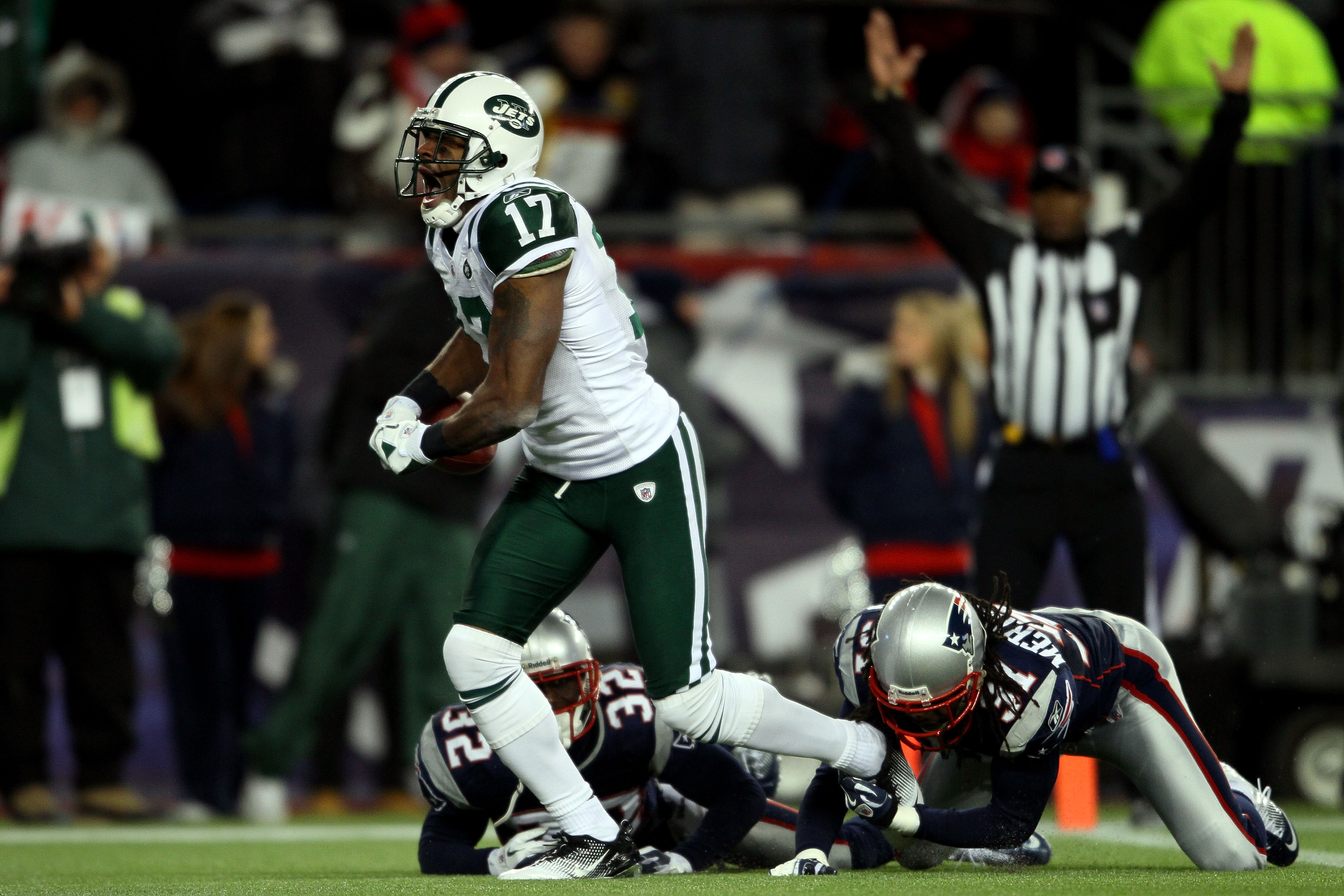 FOXBORO, MA - JANUARY 16:  Braylon Edwards #17 of the New York Jets scores a second quarter touchdown as Devin McCourty #32 and Brandon Meriweather #31 of the New England Patriots attempt to tackle during their 2011 AFC divisional playoff game at Gillette