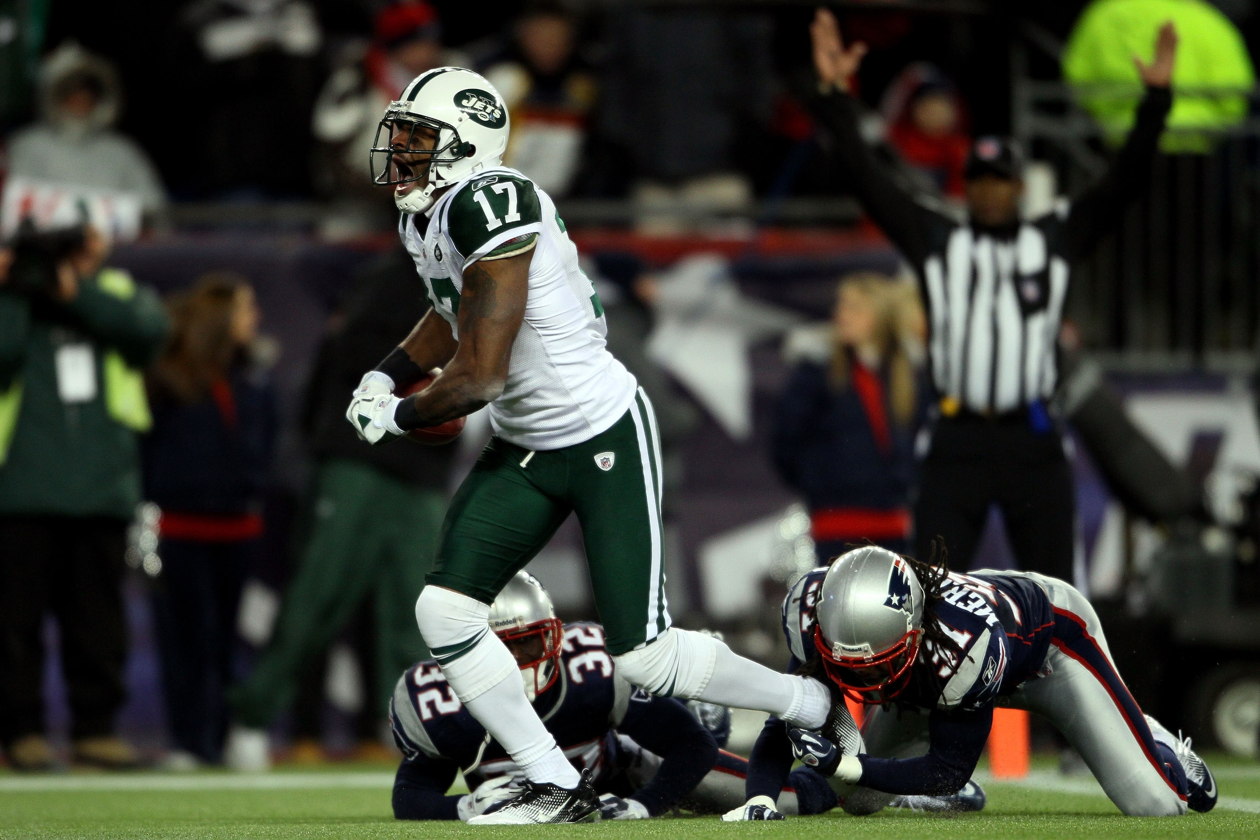 FOXBORO, MA - JANUARY 16:  Braylon Edwards #17 of the New York Jets scores a second quarter touchdown as Devin McCourty #32 and Brandon Meriweather #31 of the New England Patriots attempt to tackle during their 2011 AFC divisional playoff game at Gillette