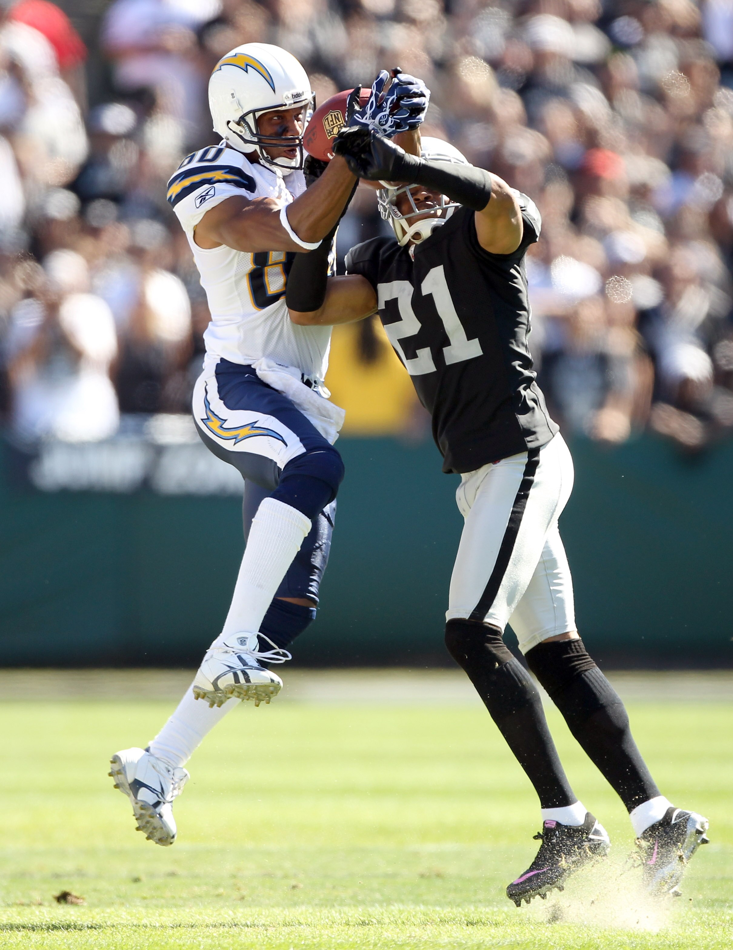 OAKLAND, CA - OCTOBER 10:  Malcom Floyd #80 of the San Diego Chargers catches a ball while defended by Nnamdi Asomugha #21 of the Oakland Raiders at Oakland-Alameda County Coliseum on October 10, 2010 in Oakland, California.  (Photo by Ezra Shaw/Getty Ima