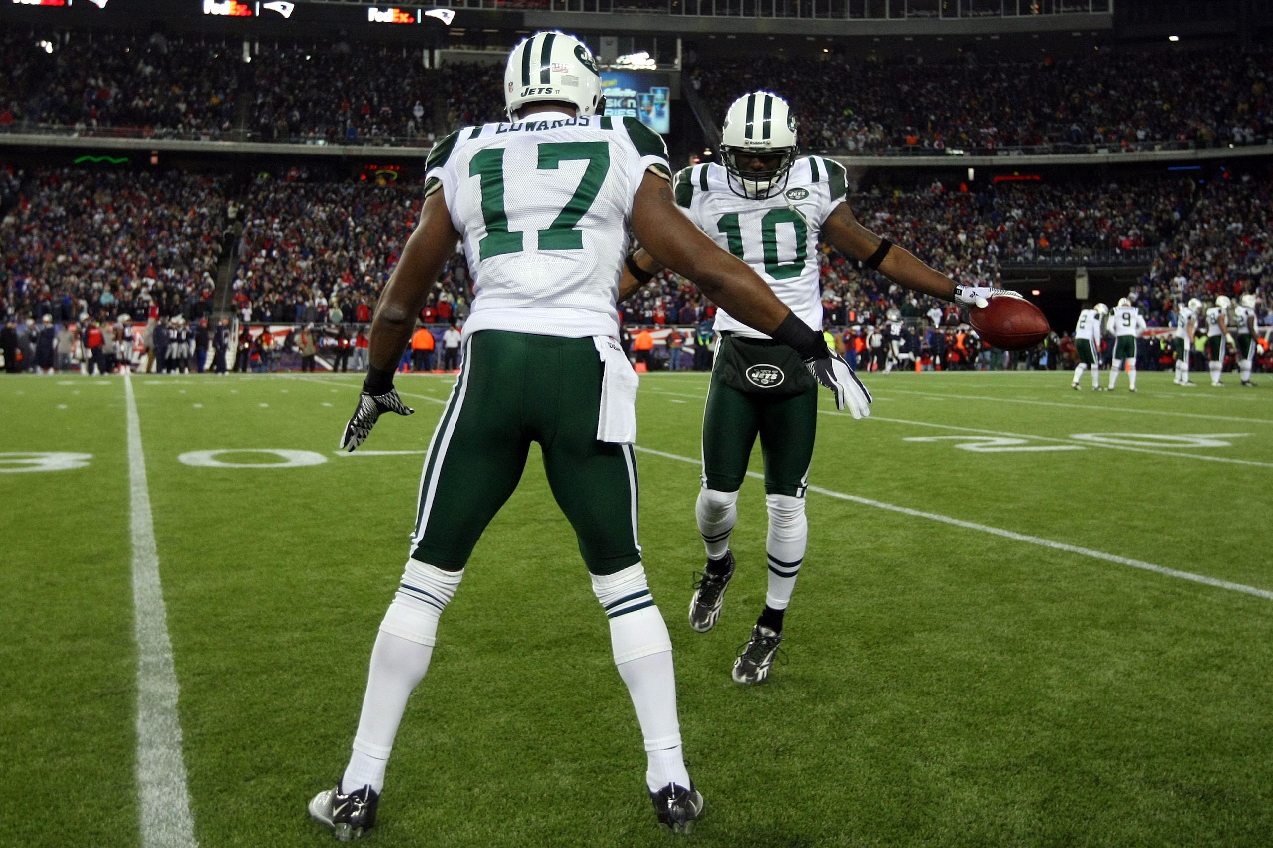 FOXBORO, MA - JANUARY 16:  Santonio Holmes #10 of the New York Jets celebrates his fourth quarter touchdown against the New England Patriots with Braylon Edwards #17 during their 2011 AFC divisional playoff game at Gillette Stadium on January 16, 2011 in
