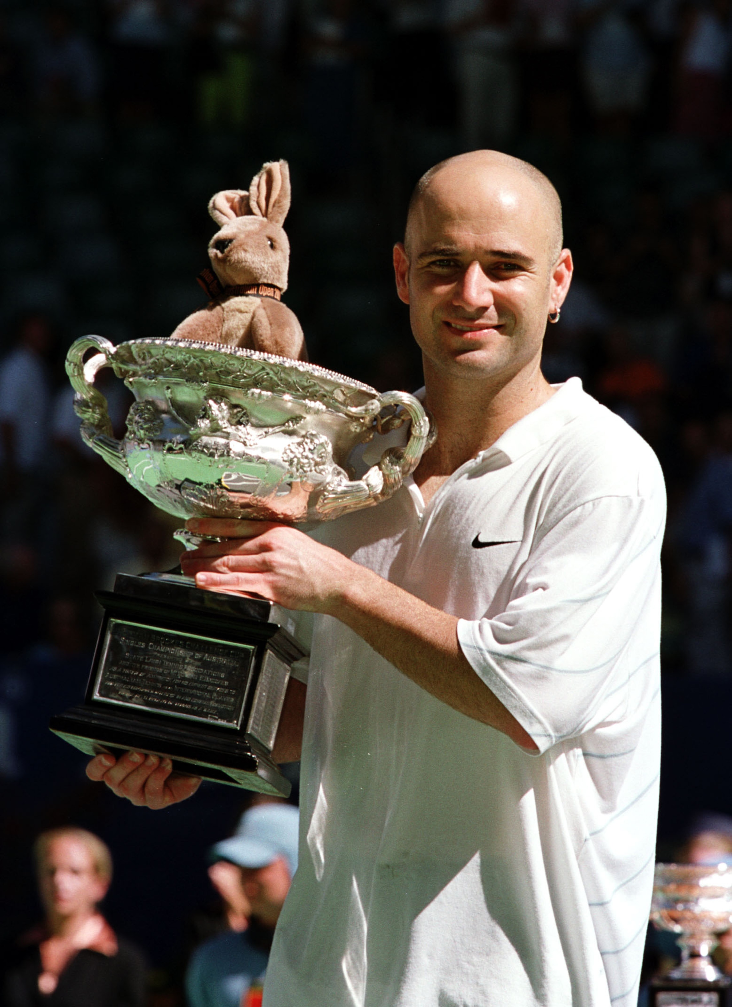 384910 02: Andre Agassi holds the championship trophy after winning the Australian Open January 28, 2001 in Melbourne, Australia. Agassi beat Arnaud Clement 6-4, 6-2, 6-2. (Photo by Darrin Braybrook/Allsport)