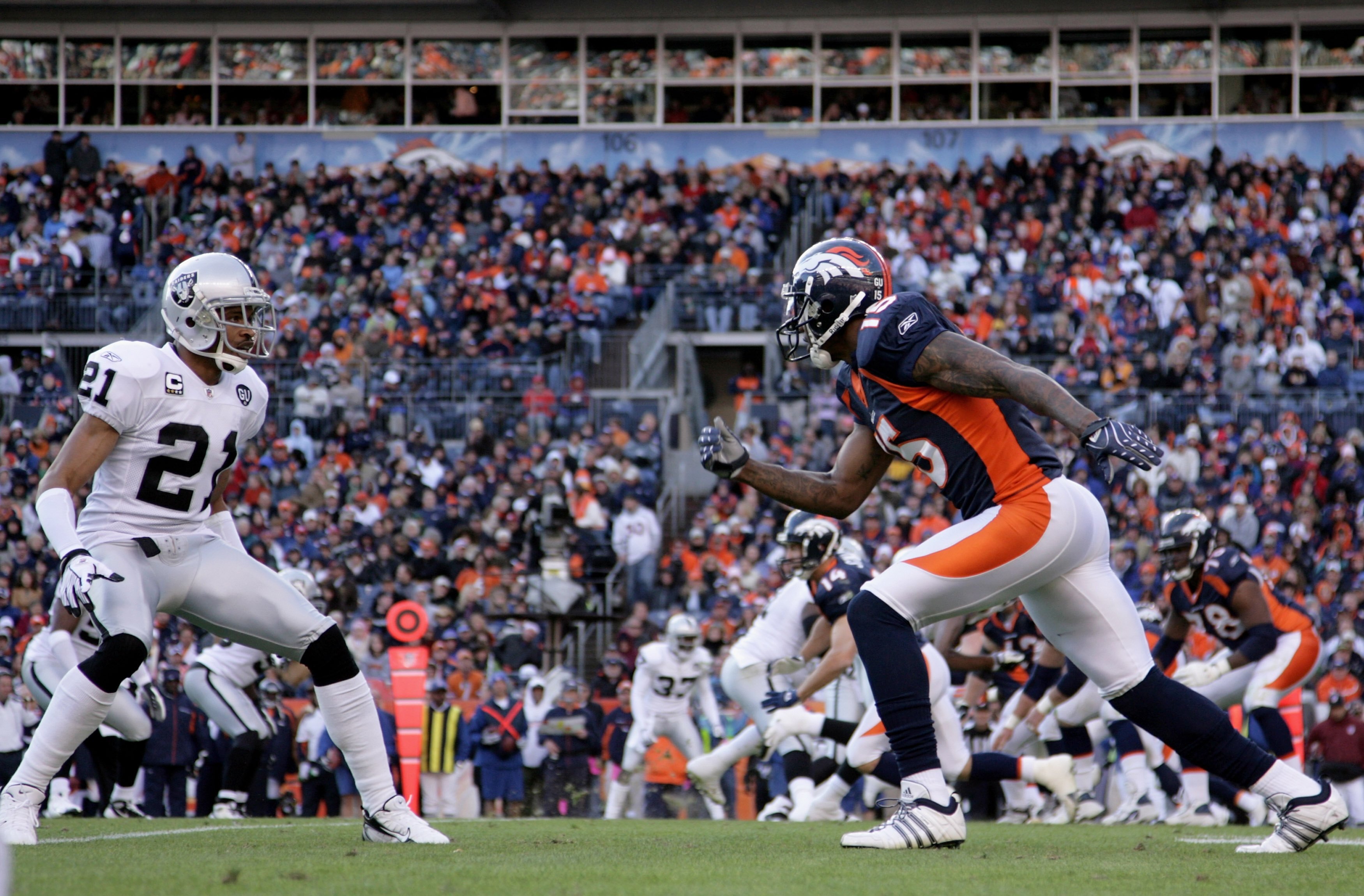 DENVER - NOVEMBER 23:  Wide receiver Brandon Marshall #15 of the Denver Broncos leaves the line of scrimmage against cornerback Nnamdi Asomgha #21 of the Oakland Raiders during week 12 NFL action at Invesco Field at Mile High on November 23, 2008 in Denve