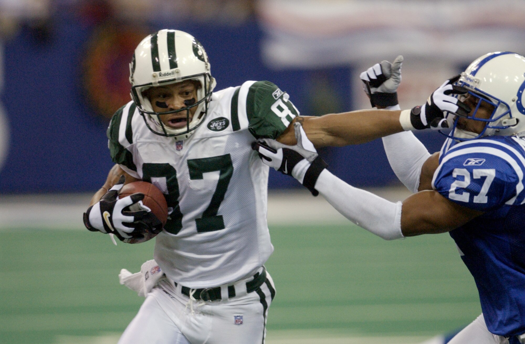 23 Dec 2001: Lavaranues Coles #87 of the new York Jets fights off David Macklin #27 of the Indianapolis Colts  during the game at the RCA Dome in Indianapolis, Indiana. The Jets won 29-28. DIGITAL IMAGE. Mandatory Credit: Ron Hoskins/Getty Images