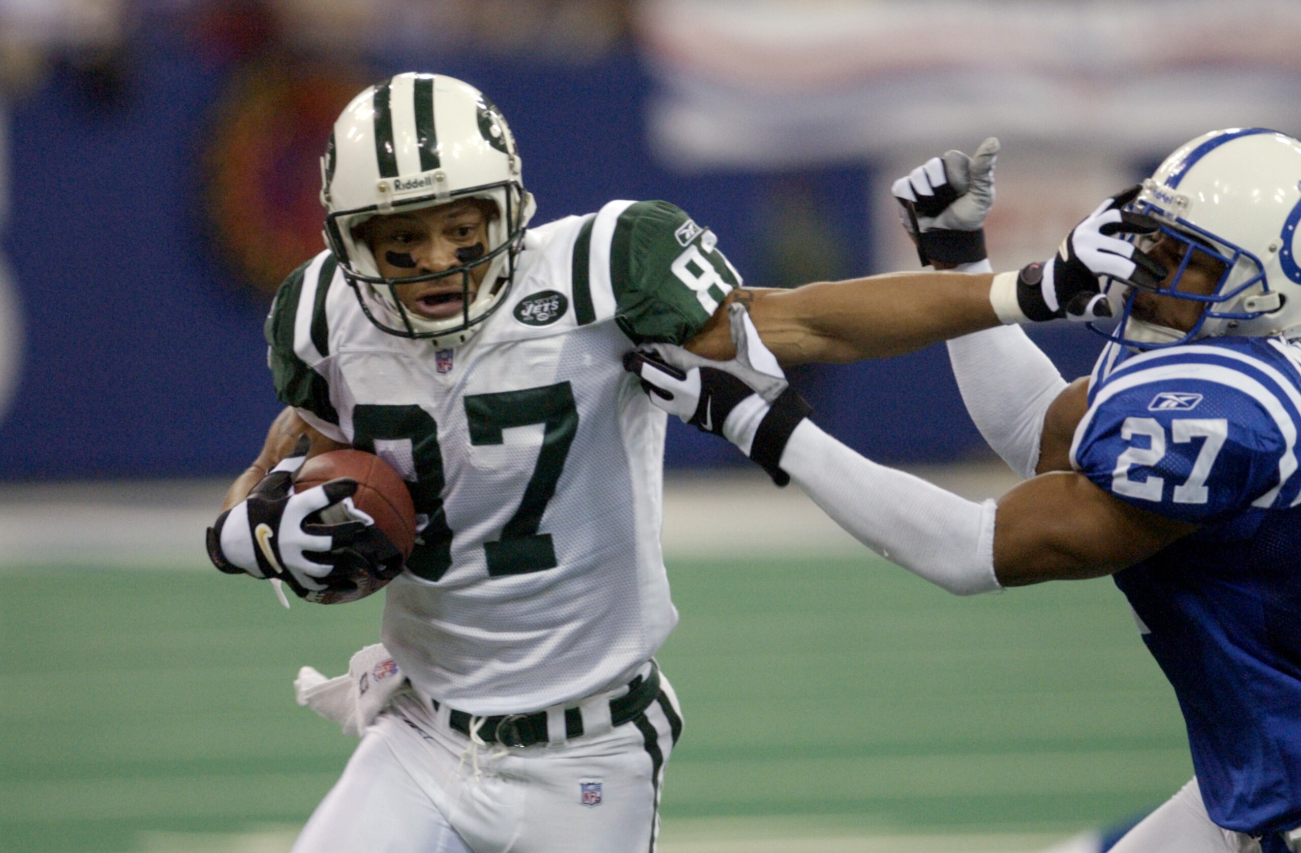 23 Dec 2001: Lavaranues Coles #87 of the new York Jets fights off David Macklin #27 of the Indianapolis Colts  during the game at the RCA Dome in Indianapolis, Indiana. The Jets won 29-28. DIGITAL IMAGE. Mandatory Credit: Ron Hoskins/Getty Images