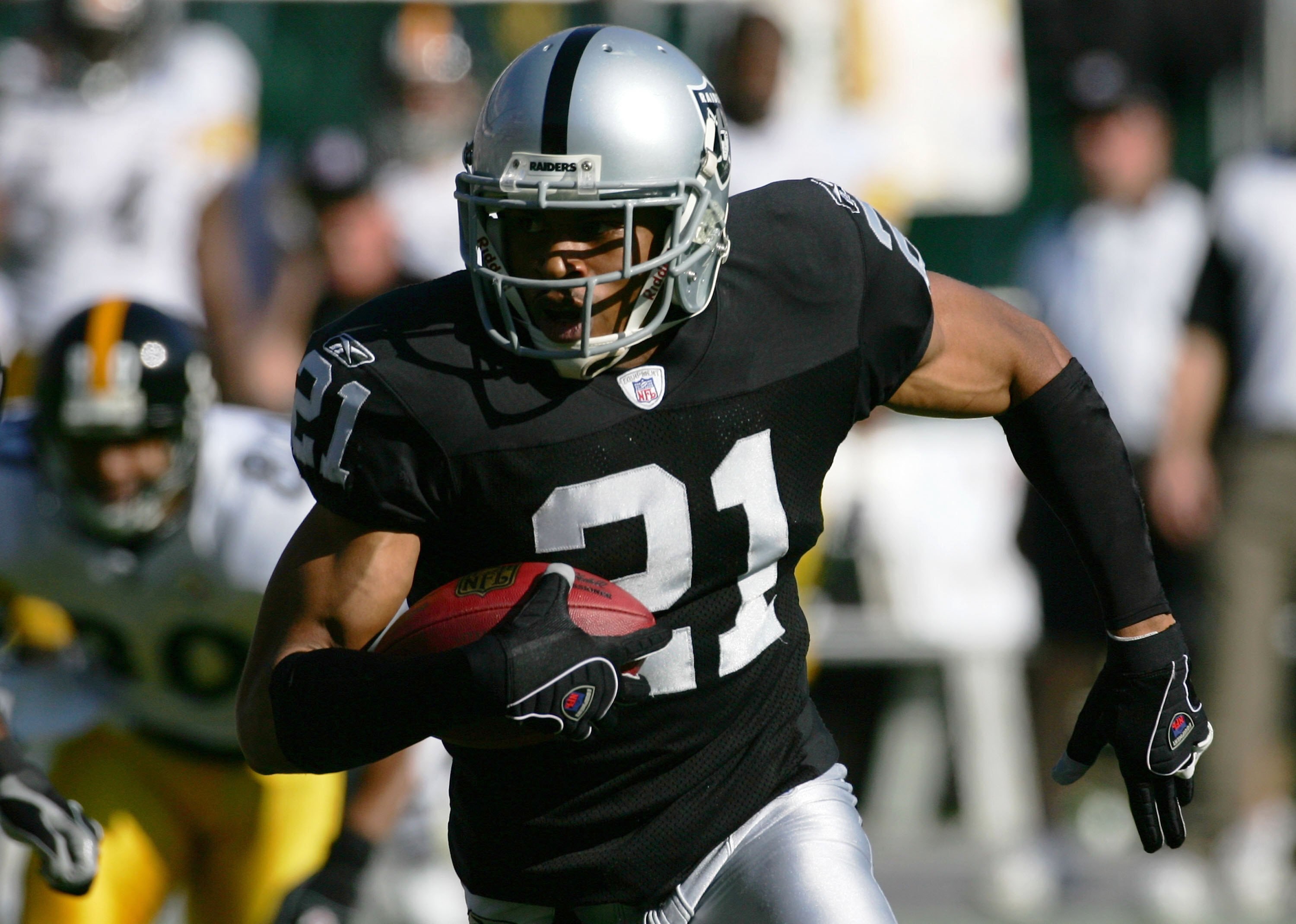 OAKLAND, CA - OCTOBER 29:  Nnamdi Asomugha #21 of the Oakland Raiders runs with the ball on an interception for a touchdown against the Pittsburgh Steelers on October 29, 2006 at McAfee Coliseum in Oakland, California.  (Photo by Robert Laberge/Getty Imag