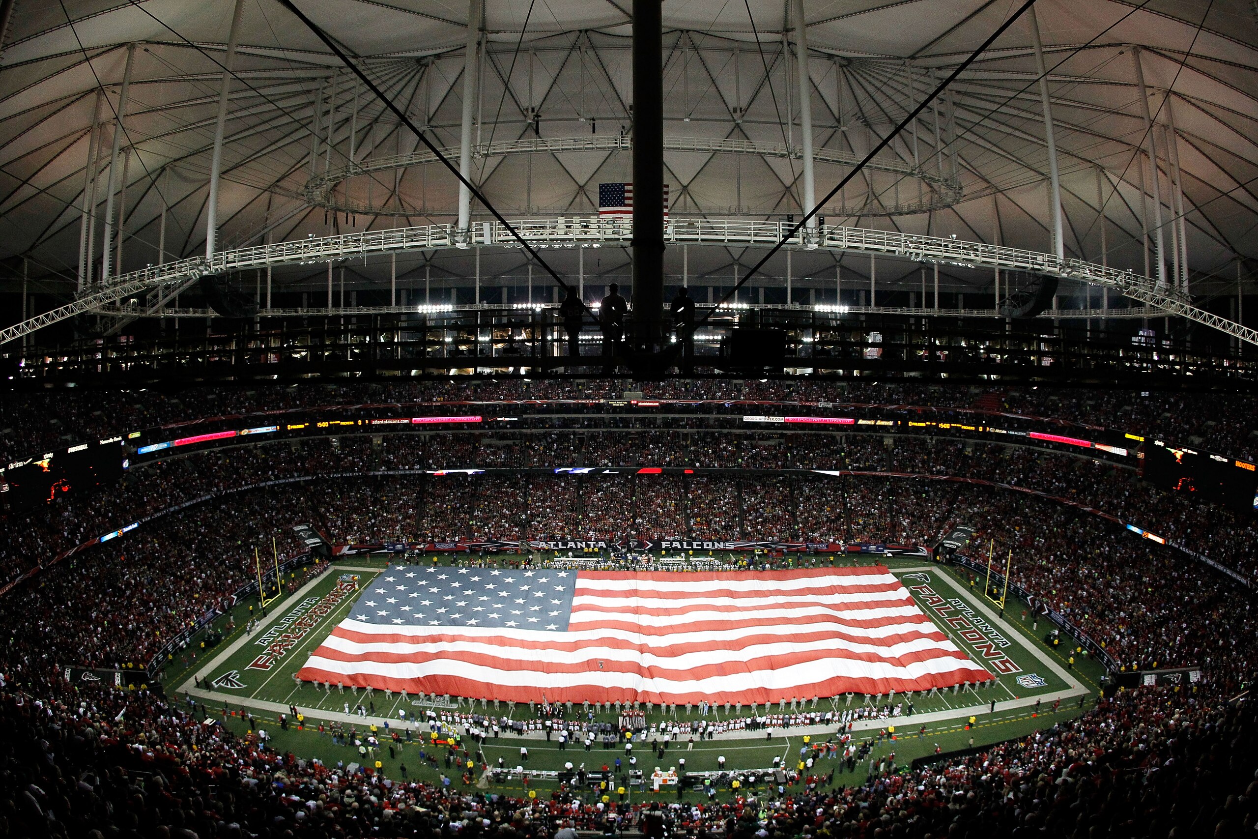 ATLANTA, GA - JANUARY 15:  A general view of a giant American Flag as it's stretched across the field for the performance of the National Anthem prior to the Atlanta Falcons playing against the Green Bay Packers during their 2011 NFC divisional playoff ga