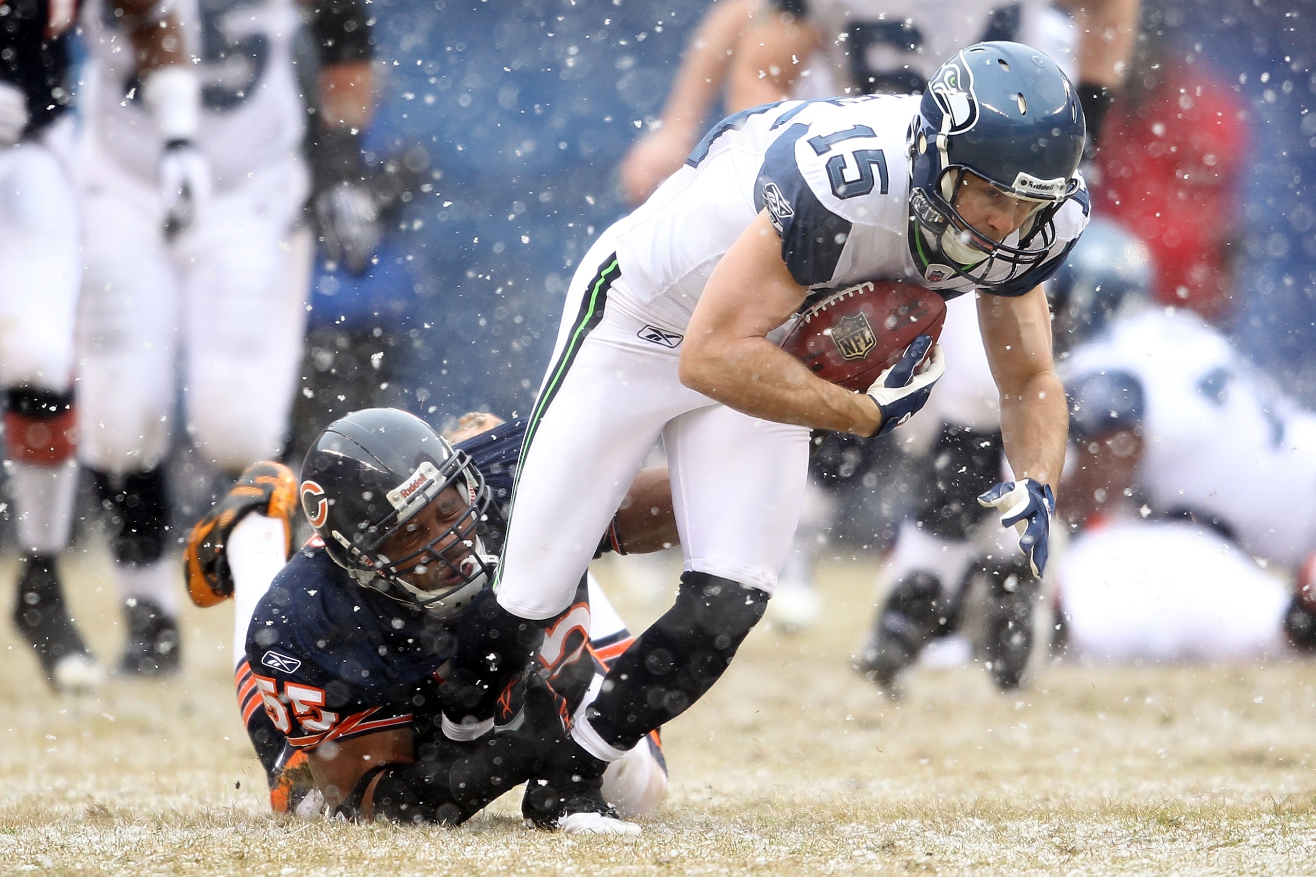 CHICAGO, IL - JANUARY 16:  Brandon Stokley #15 of the Seattle Seahawks attempts to run after a catch as Lance Briggs #55 of the Chicago Bears attempts to tackle him in the first half in the 2011 NFC divisional playoff game at Soldier Field on January 16,