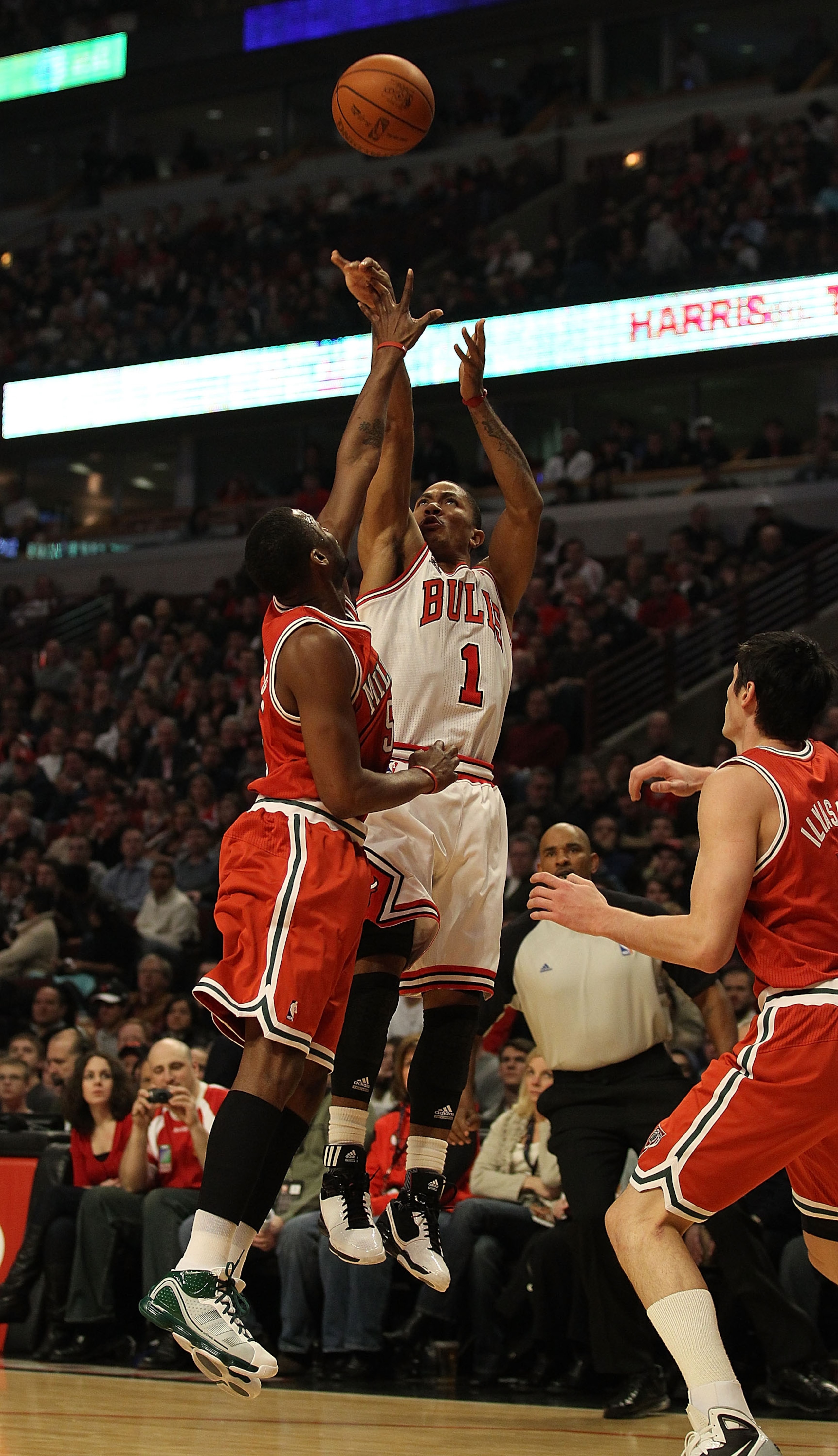 CHICAGO, IL - DECEMBER 28: Derrick Rose #1 of the Chicago Bulls puts up a shot against Keyon Dooling #55 and Ersan Ilyasova #7 of the Milwaukee Bucks at the United Center on December 28, 2010 in Chicago, Illinois. The Bulls defeated the Bucks 90-77. NOTE