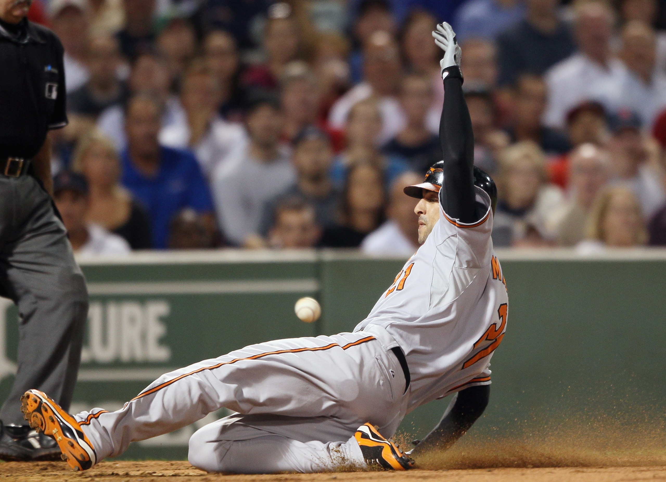 BOSTON - SEPTEMBER 22: Nick Markakis #21 of the Baltimore Orioles beats the throw to score on a double from teammate Ty Wigginton in the fourth inning against the Boston Red Sox on September 22, 2010 at Fenway Park in Boston, Massachusetts. (Photo by El BOSTON - SEPTEMBER 22: Nick Markakis #21 of the Baltimore Orioles beats the throw to score on a double from teammate Ty Wigginton in the fourth inning against the Boston Red Sox on September 22, 2010 at Fenway Park in Boston, Massachusetts. (Photo by El