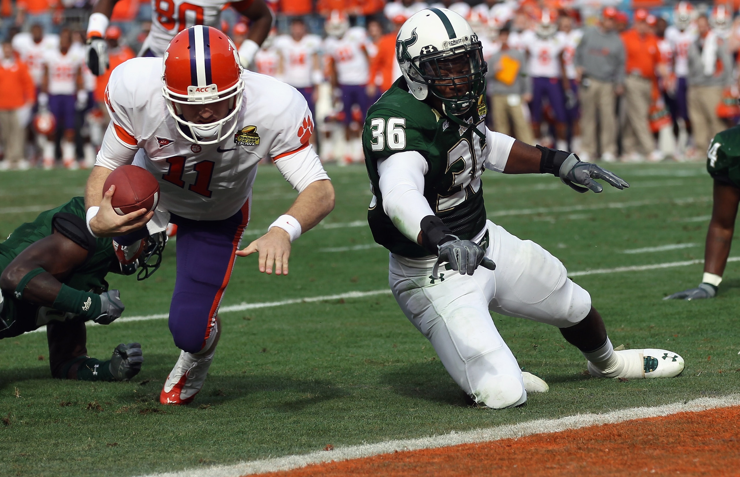 CHARLOTTE, NC - DECEMBER 31:  Sam Barrington #36 of the USF Bulls hits Kyle Parker #11 of the Clemson Tigers short of the goal line during their game at Bank of America Stadium on December 31, 2010 in Charlotte, North Carolina.  (Photo by Streeter Lecka/G