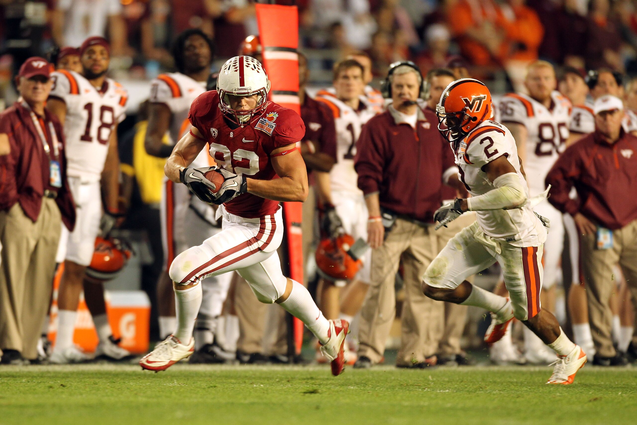 MIAMI, FL - JANUARY 03:  Coby Fleener #82 of the Stanford Cardinal catches a 58-yard touchdown in the fourth quarter against Davon Morgan #2 of the Virginia Tech Hokies during the 2011 Discover Orange Bowl at Sun Life Stadium on January 3, 2011 in Miami,