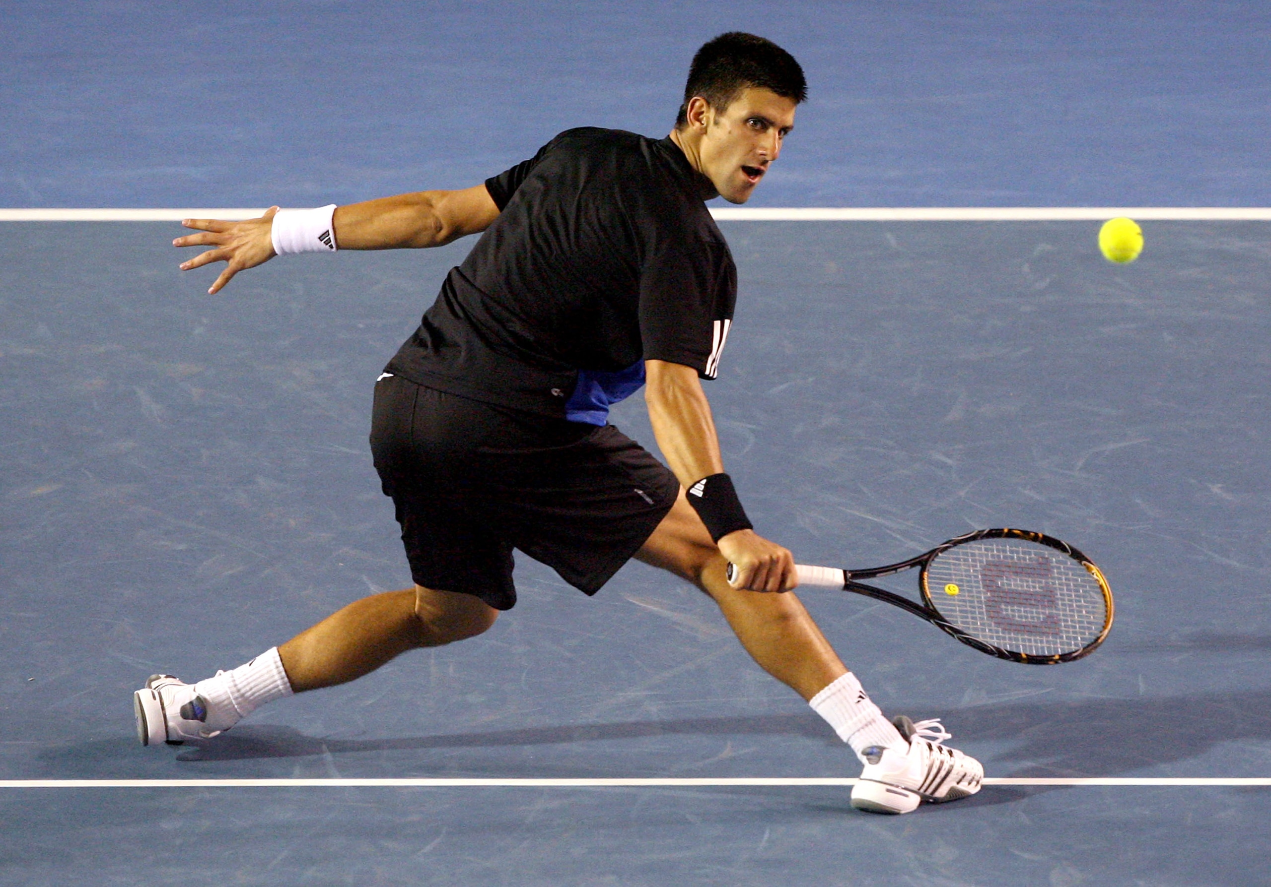 MELBOURNE, AUSTRALIA - JANUARY 27:  Novak Djokovic of Serbia plays a backhand during his men's final match against Jo-Wilfried Tsonga of France on day fourteen of the Australian Open 2008 at Melbourne Park on January 27, 2008 in Melbourne, Australia.  (Ph