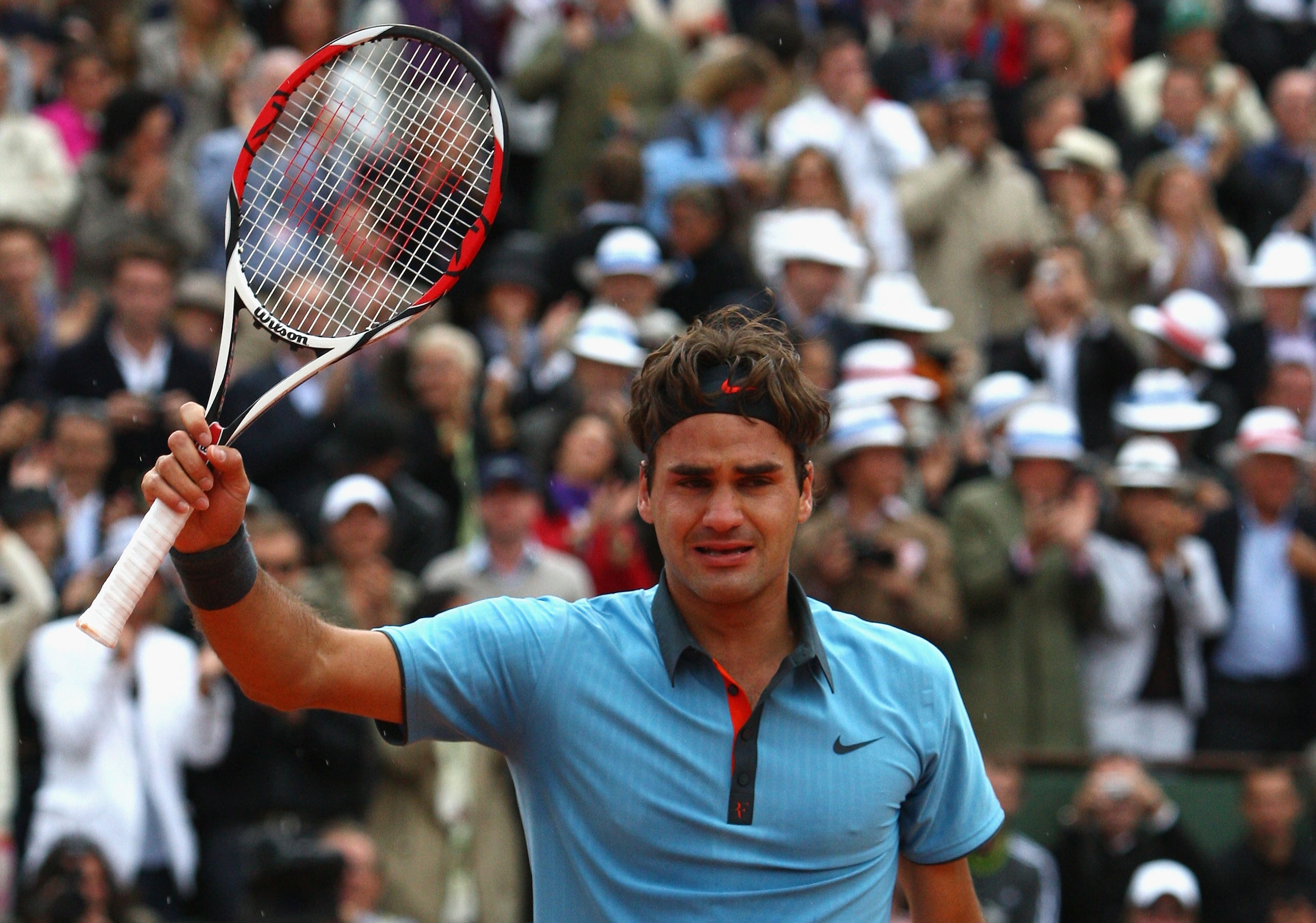PARIS - JUNE 07:  An emotional Roger Federer of Switzerland salutes the fans following his victory during the Men's Singles Final match against Robin Soderling of Sweden on day fifteen of the French Open at Roland Garros on June 7, 2009 in Paris, France.