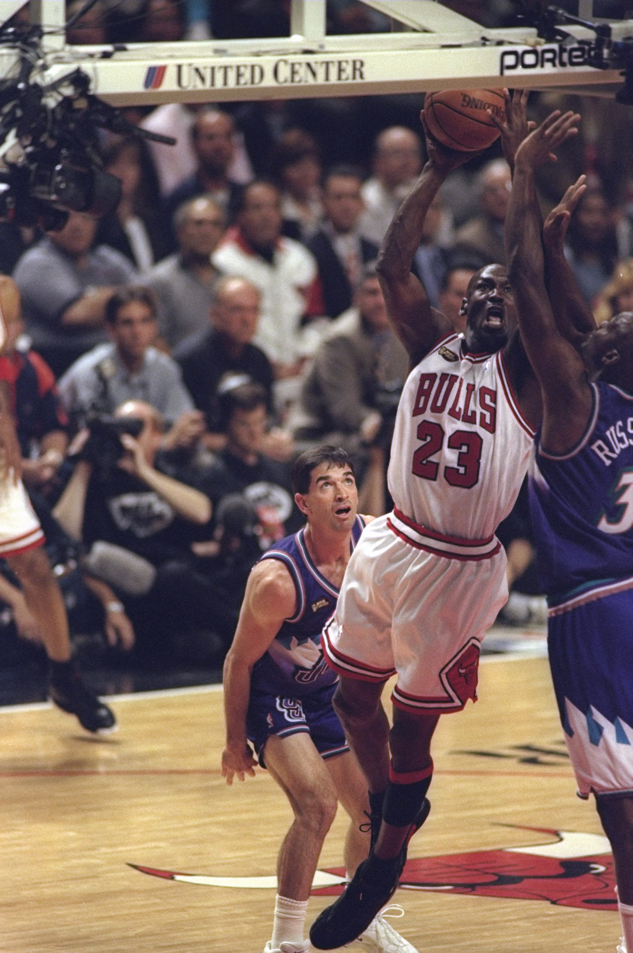 10 Jun 1998: Michael Jordan #23 of the Chicago Bulls in action against John Stockton #12 and Bryon Russell #3 of the Utah Jazz during the NBA Finals Game 4 at the United Center in Chicago, Illinois. The Bulls defeated the Jazz 86-82. Mandatory Credit: M
