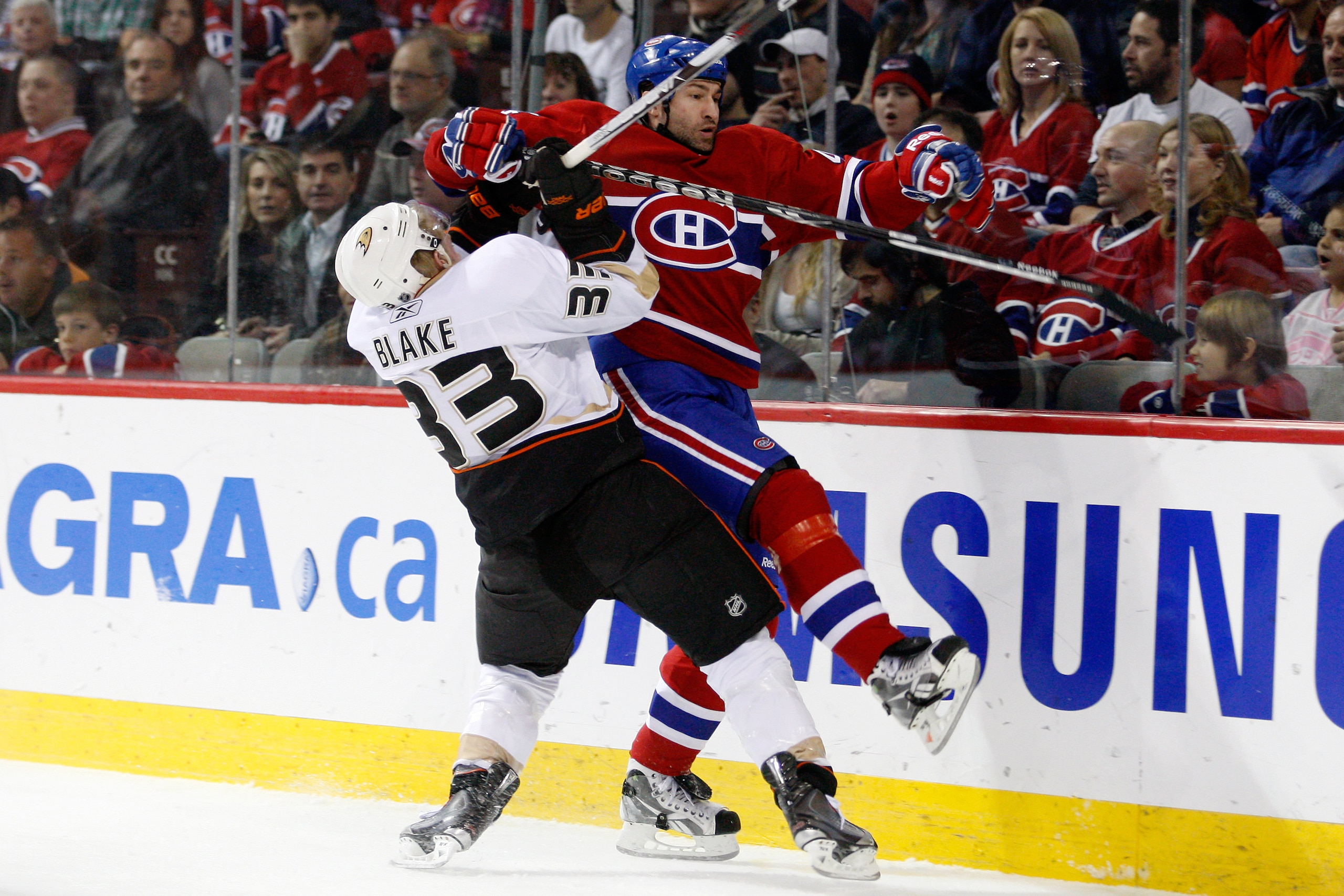 MONTREAL, CANADA - JANUARY 22:  Jason Blake #33 of the Anaheim Ducks body checks Roman Hamrlik #44 of the Montreal Canadiens during the NHL game at the Bell Centre on January 22, 2011 in Montreal, Quebec, Canada.  (Photo by Richard Wolowicz/Getty Images)