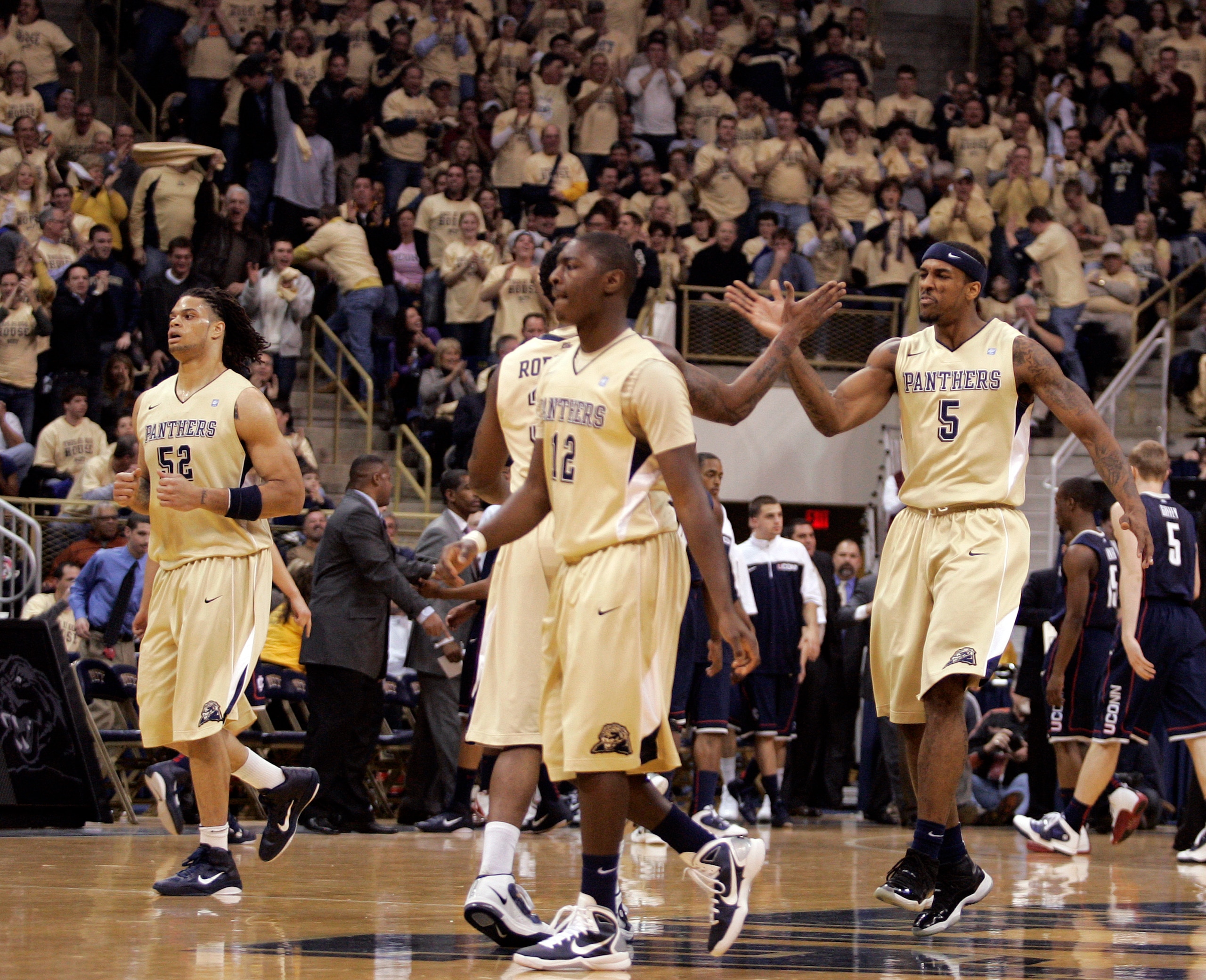 PITTSBURGH, PA - DECEMBER 27:  Gilbert Brown #5 of the Pittsburgh Panthers celebrates a dunk with teammates against the Connecticut Huskies at Petersen Events Center on December 27, 2010 in Pittsburgh, Pennsylvania.  (Photo by Justin K. Aller/Getty Images