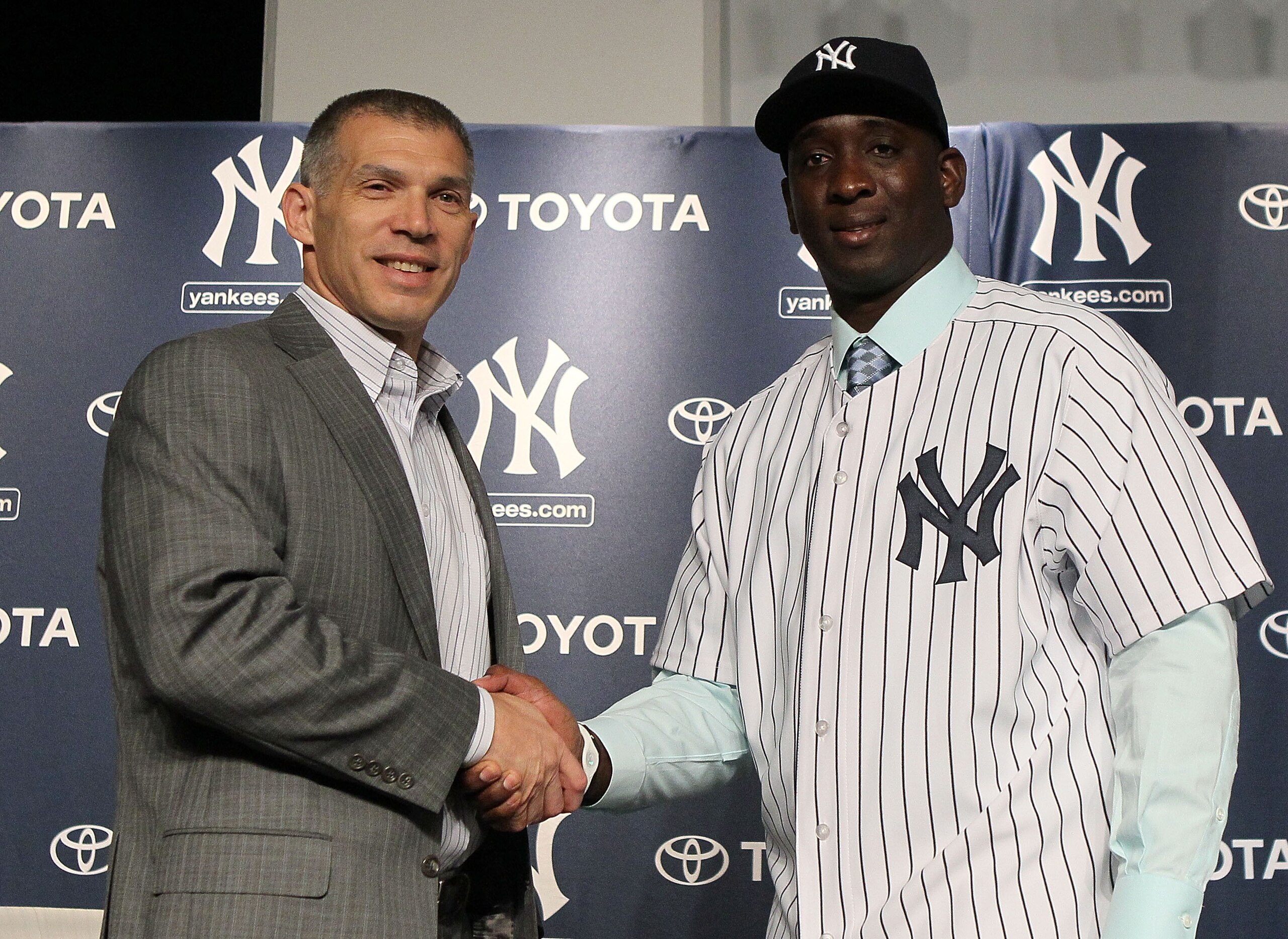 NEW YORK, NY - JANUARY 19:  Rafael Soriano (R) of the New York Yankees shakes hands with manager Joe Girardi during a press conference on January 19, 2011 at Yankee Stadium in the Bronx borough of New York City. The Yankees signed Soriano to a three year