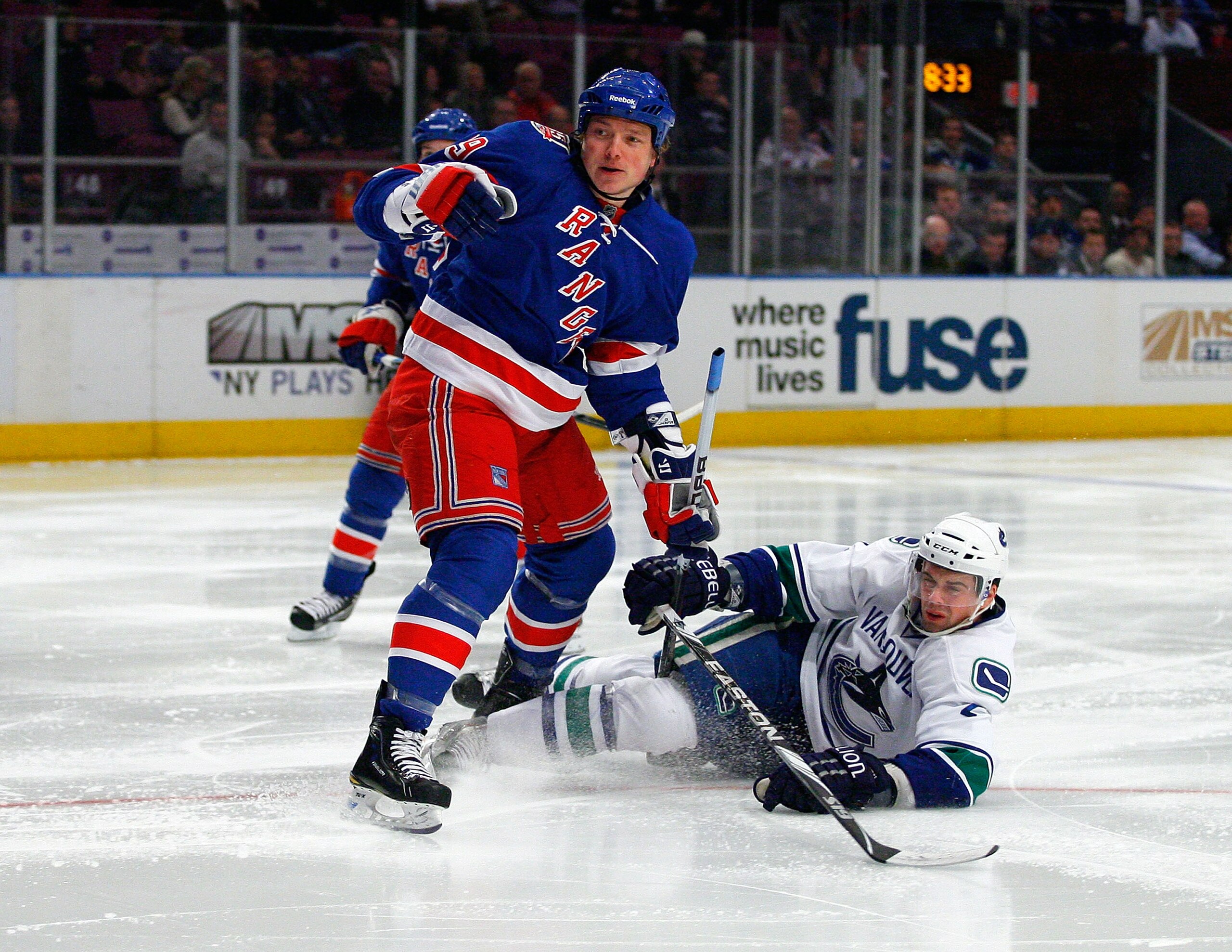 NEW YORK , NY - JANUARY 13: Dan Hamhuis #2 of the Vancouver Canucks is knocked to the ice by Ruslan Fedotenko #19 of the New York Rangers during the game at Madison Square Garden on January 13, 2011 in New York City. (Photo by Andy Marlin/Getty Images)