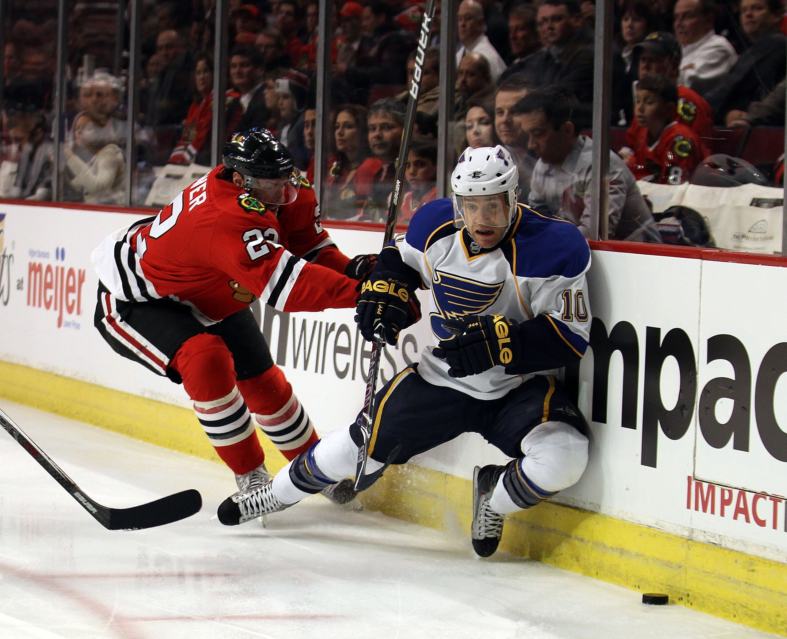CHICAGO - NOVEMBER 30: Troy Brouwer #22 of the Chicago Blackhawks knocks down Andy McDonald #10 of the St. Louis Blues as they battle for the puck at the United Center on November 30, 2010 in Chicago, Illinois. (Photo by Jonathan Daniel/Getty Images)
