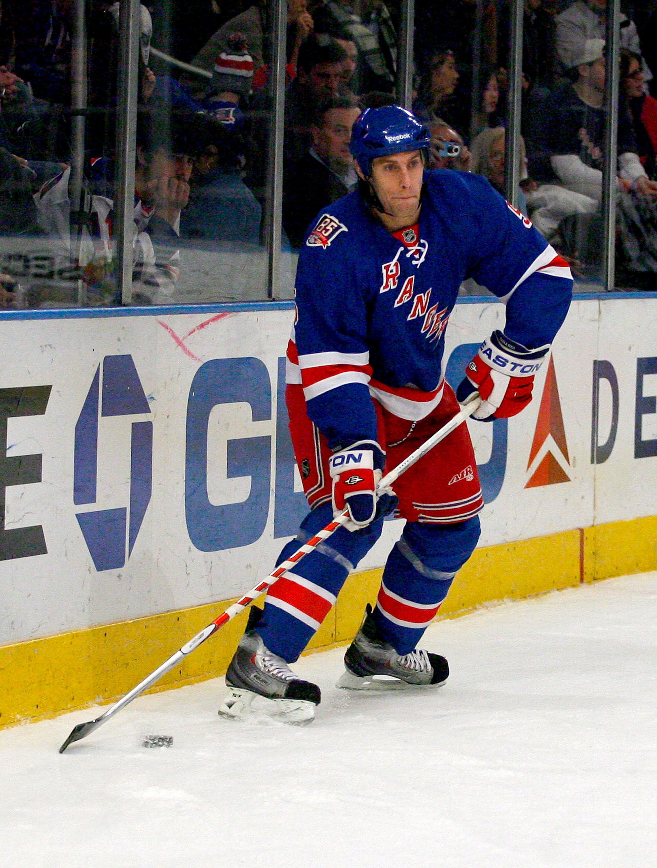 NEW YORK , NY - JANUARY 13: Dan Girardi #5  of the New York Rangers plays the puck against the Vancouver Canucks during the game at Madison Square Garden on January 13, 2011 in New York City. (Photo by Andy Marlin/Getty Images)