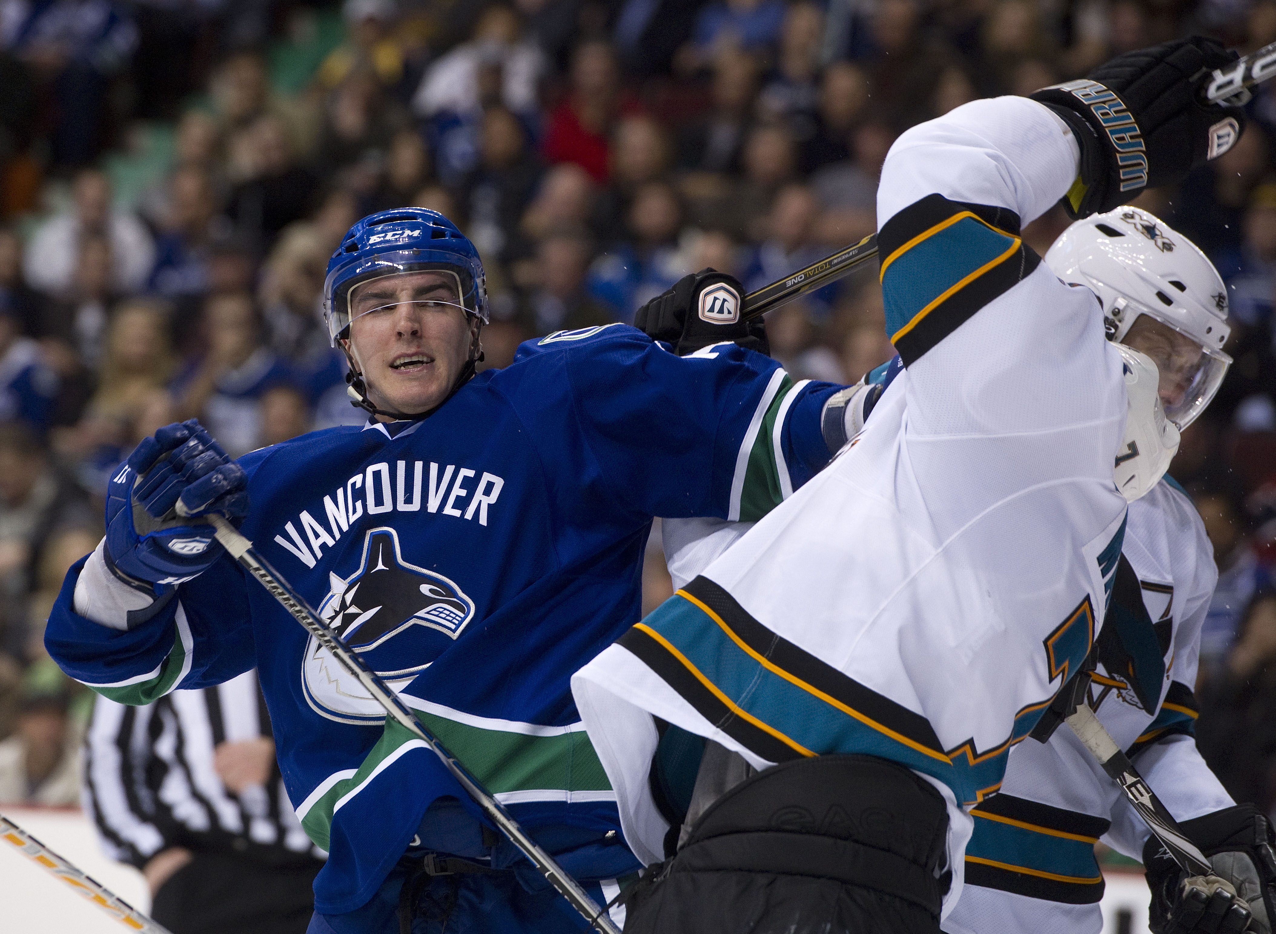VANCOUVER, CANADA - JANUARY 20: Alexandre Burrows #14 of the Vancouver Canucks reacts while roughing it up with Niclas Wallin #7 of the San Jose Sharks after the whistle during the second period in NHL action on January 20, 2011 at Rogers Arena in Vancouv
