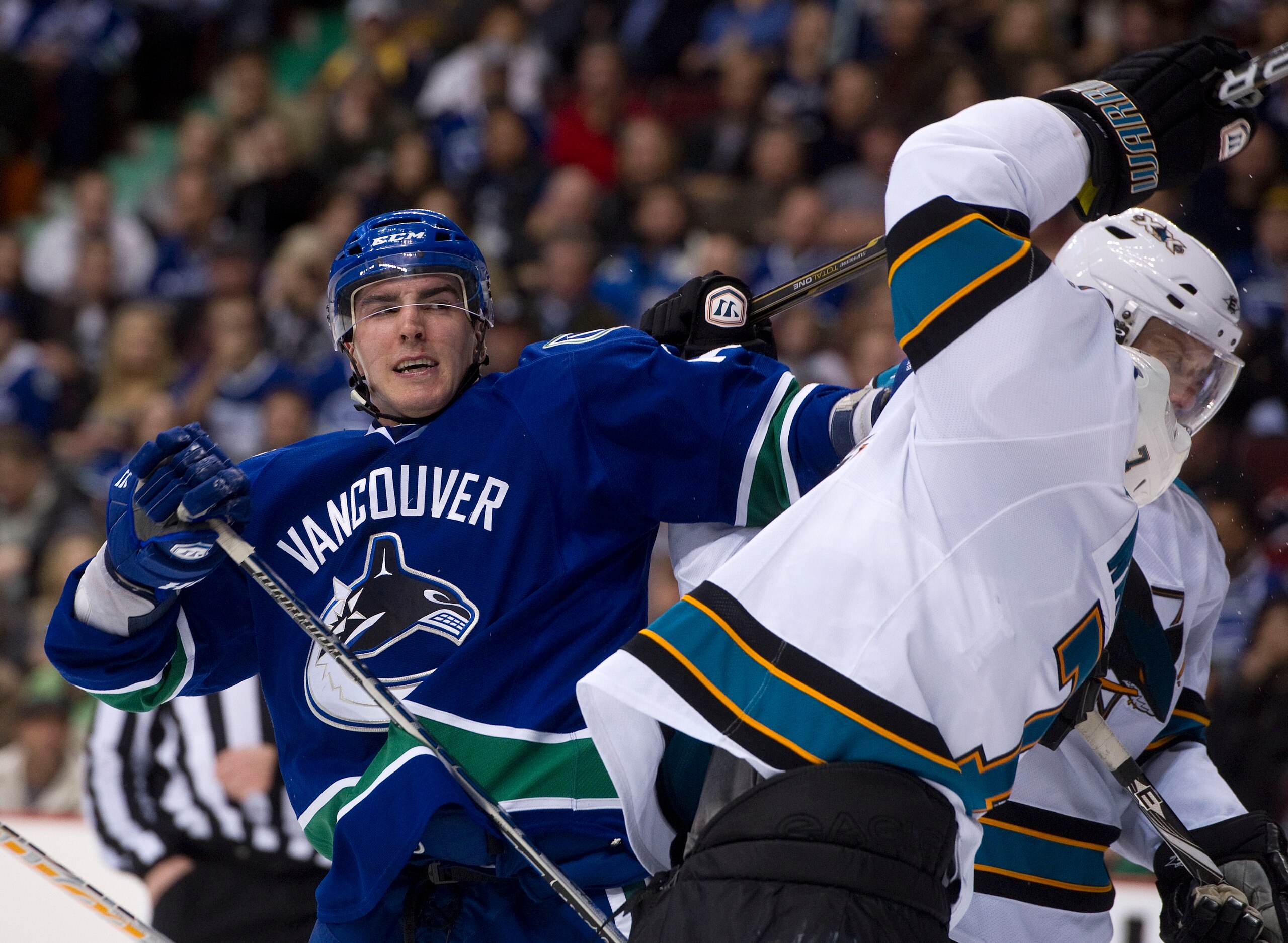 VANCOUVER, CANADA - JANUARY 20: Alexandre Burrows #14 of the Vancouver Canucks reacts while roughing it up with Niclas Wallin #7 of the San Jose Sharks after the whistle during the second period in NHL action on January 20, 2011 at Rogers Arena in Vancouv