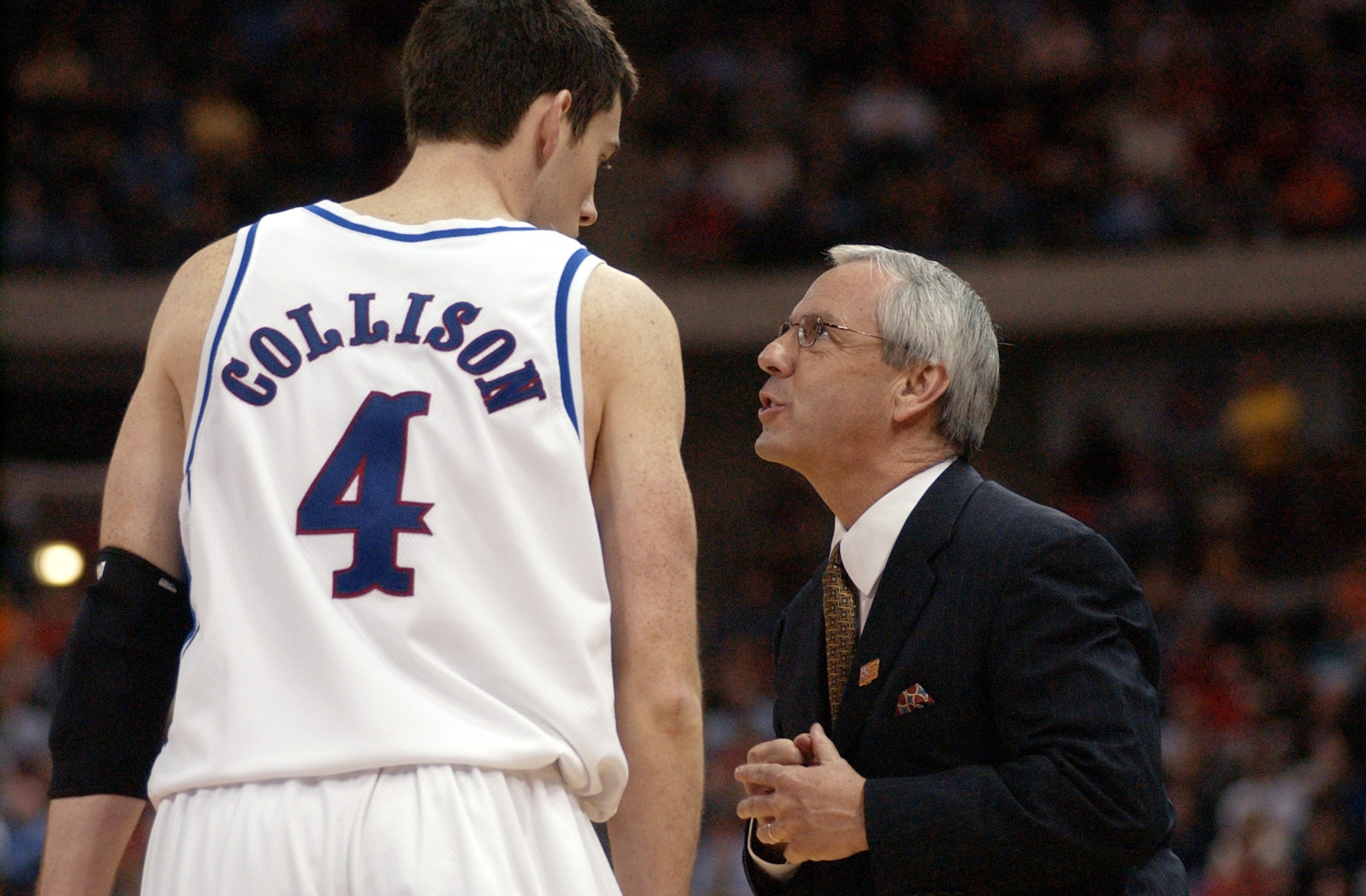 22 Mar 2002: Head coach Roy Williams of Kansas talks with his player Nick Collison #4 during a time out against Illinois during the third round of the NCAA Mens Basketball Tournament at the Kohl Center in Madison, Wisconsin. Kansas beat Illinois 73-69. DI